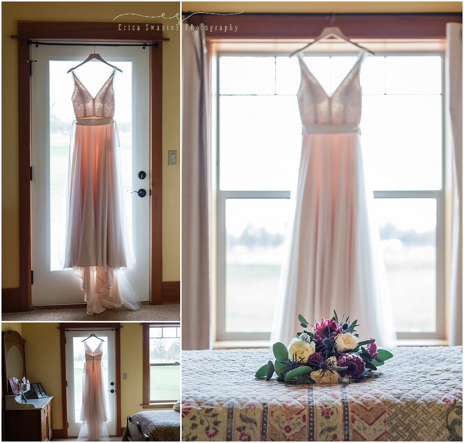 A gorgeous cream colored wedding gown, with simple flowing fabric hanging in a backlit window.