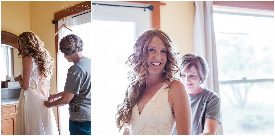 Mother of the bride helps zip this smiling bride into her beautiful cream colored gown. 