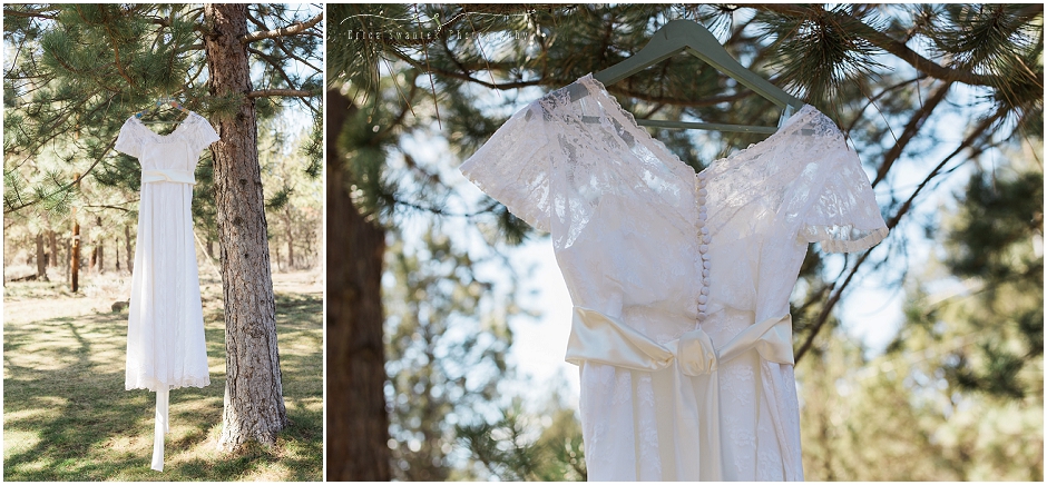 Vintage lace wedding gown hangs from a pine tree in the woods at this backyard wedding outside of Sisters, OR. 