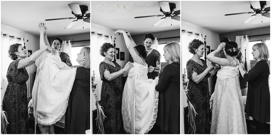 Black and white images of the bride's mom helping her into her lacy bohemian vintage wedding gown. 