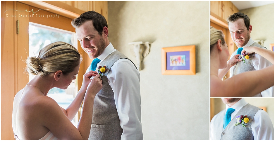A handsome groom has his boutonniere pinned to his vest by his sister before he marries.