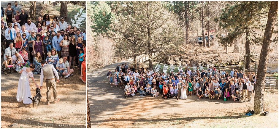 A large group shot from a rustic backyard wedding in the woods surrounds Sisters, OR. 