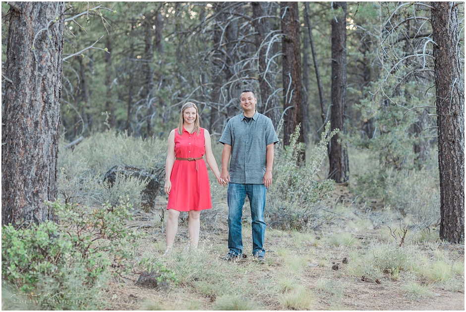 Beautiful couple wearing coral and gray at their engagment session in the pines of Central Oregon. 