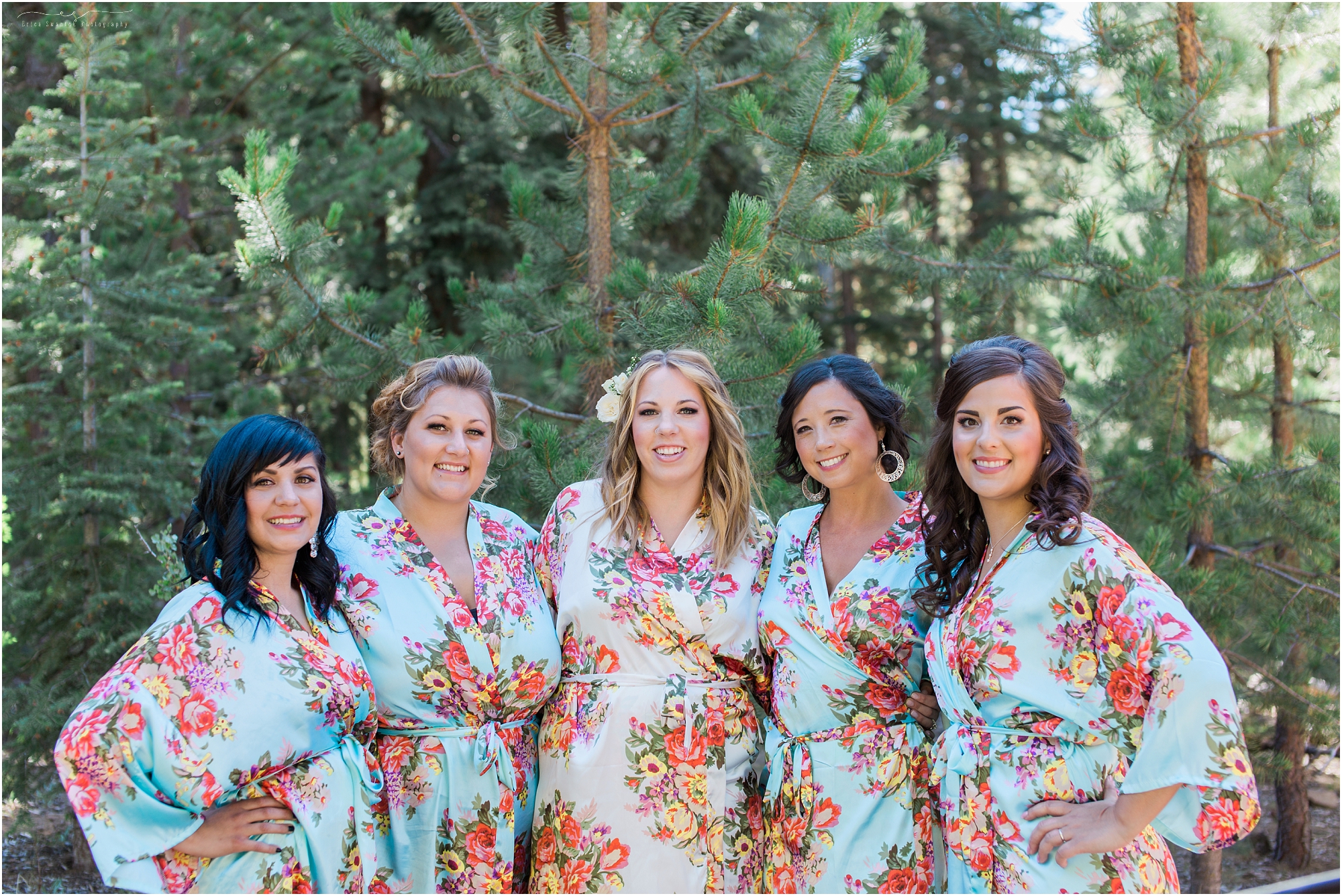 Beautiful bride and bridesmaids wearing floral robes as they get ready for the day.