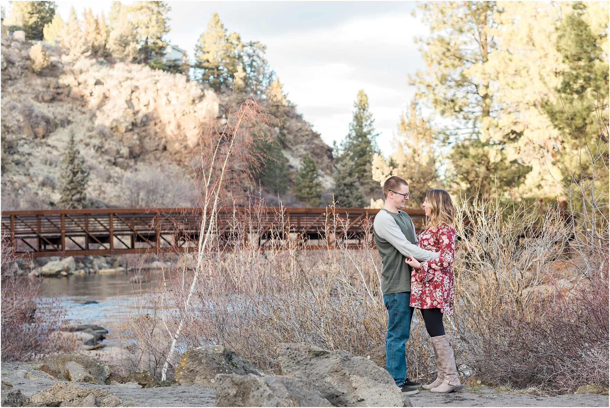 A couple looks tenderly at each other at their outdoor engagement photo session in Bend, OR. 