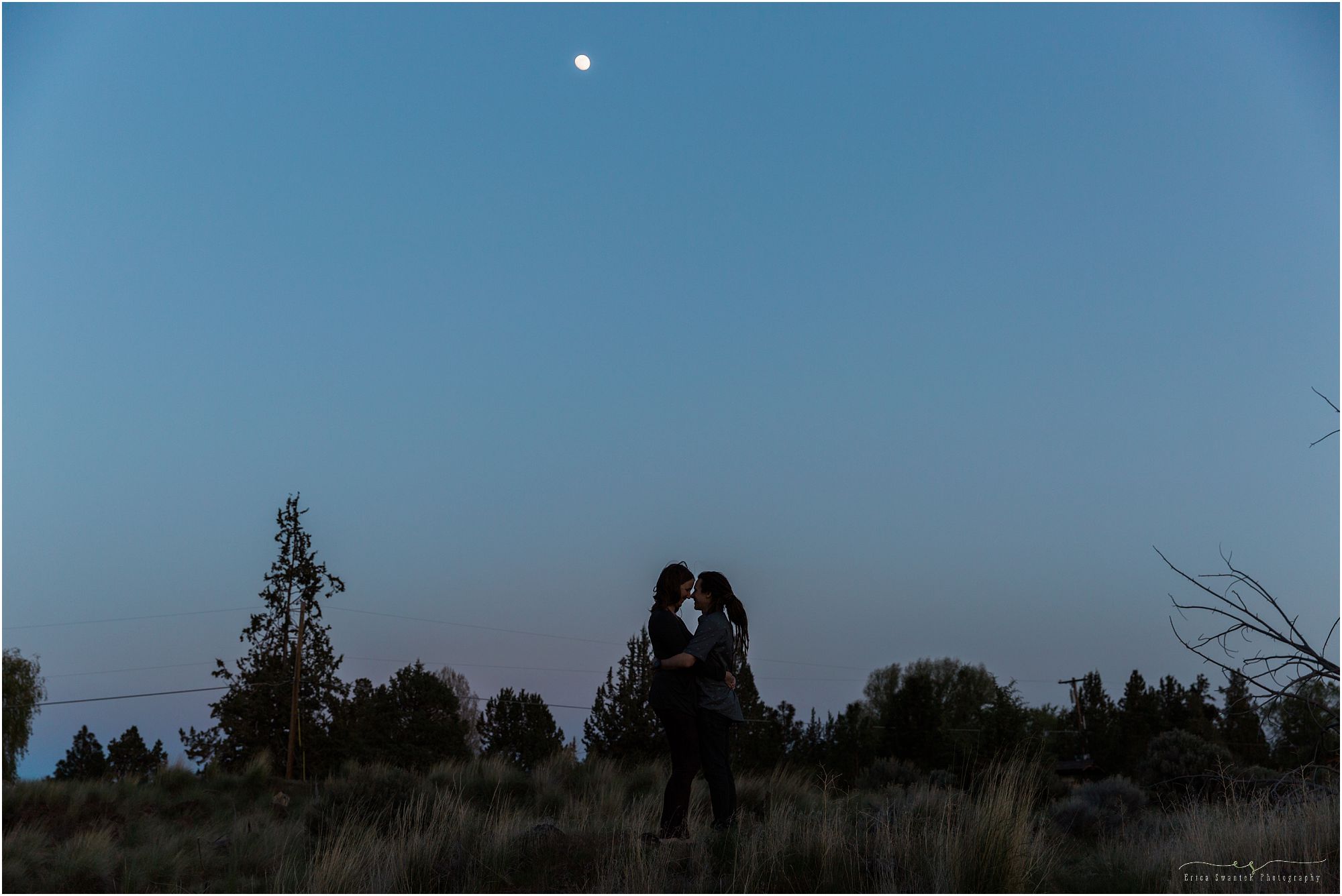 The sun had set and the beautiful blue hour was beginning with a crescent moon to create a perfect silhouette against the night sky at this Smith Rock Engagement Session. | Erica Swantek Photography