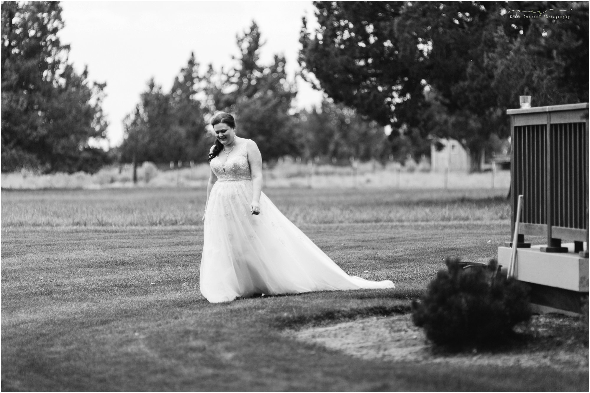 A gorgeous black and white photo of a bride walking out to her first look with her handsome husband waiting in Bend, OR. | Erica Swantek Photography