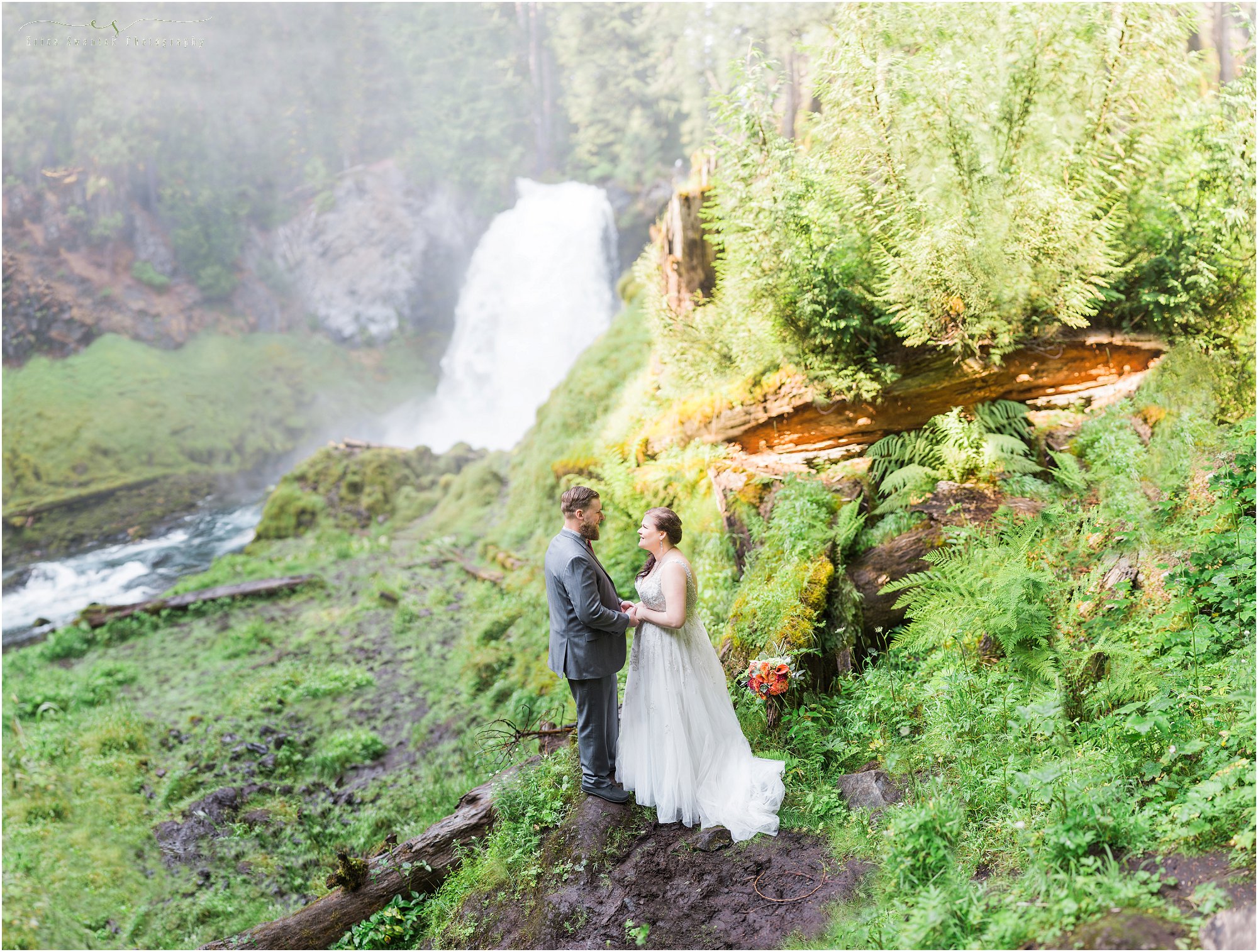 A couple stands at the base of Sahalie Falls at this Intimate Oregon waterfall wedding near Bend. | Erica Swantek Photography