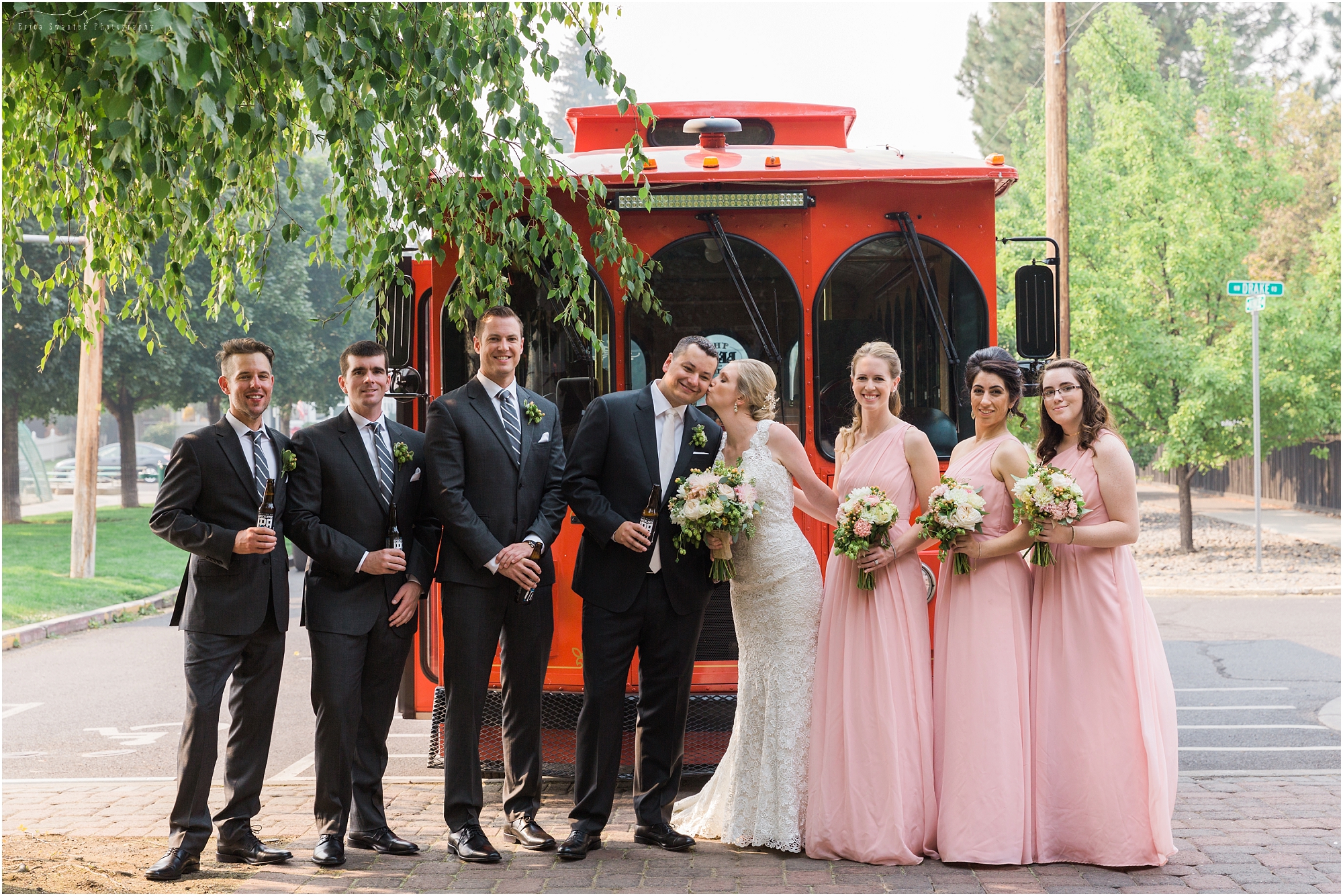 Deschutes Brewery Wedding attendants pose in front of the Bend Trolley. 
