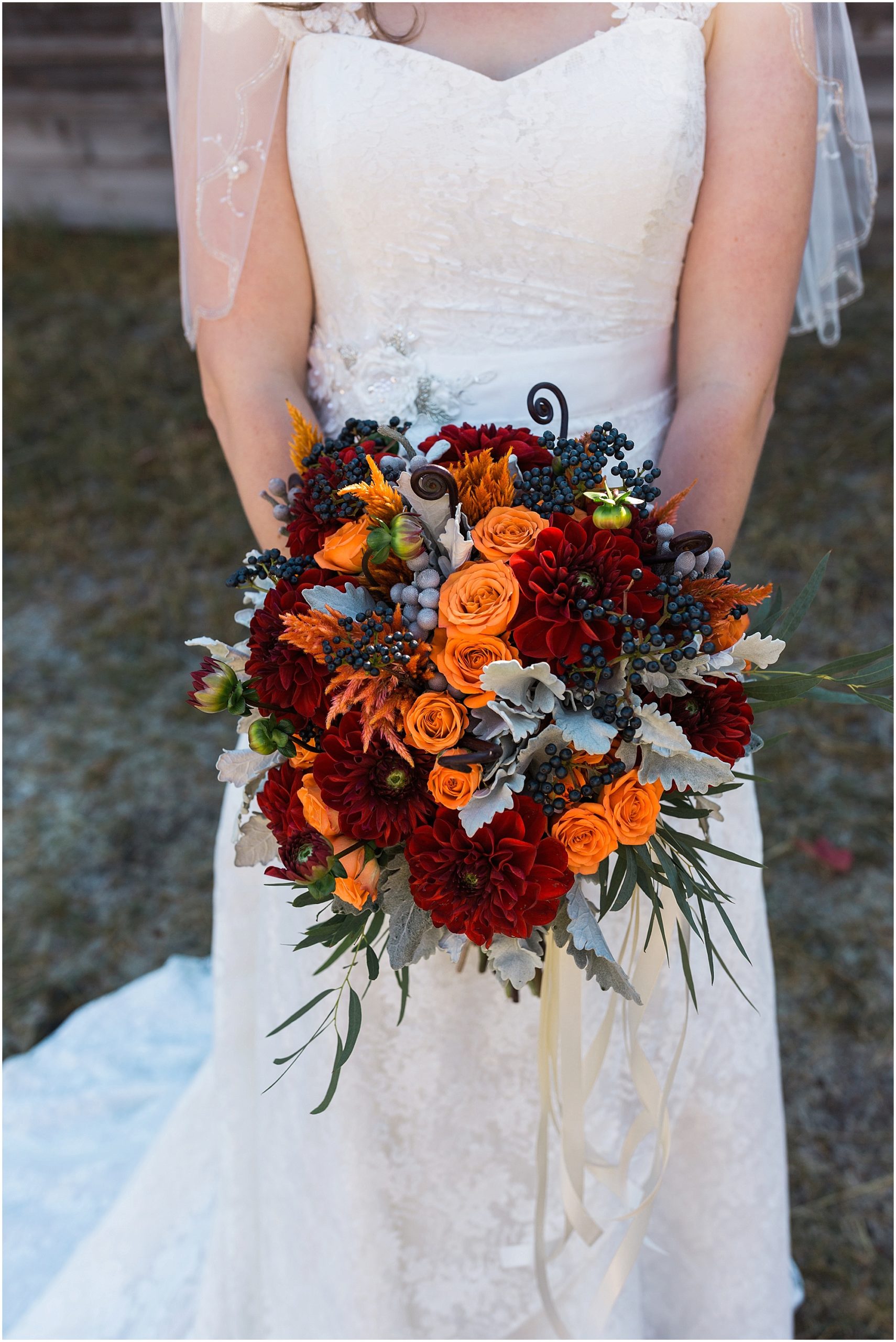 A stunning bouquet in rich oranges and reds created by Cascade Garden Florist in Bend, OR. | Erica Swantek Photography