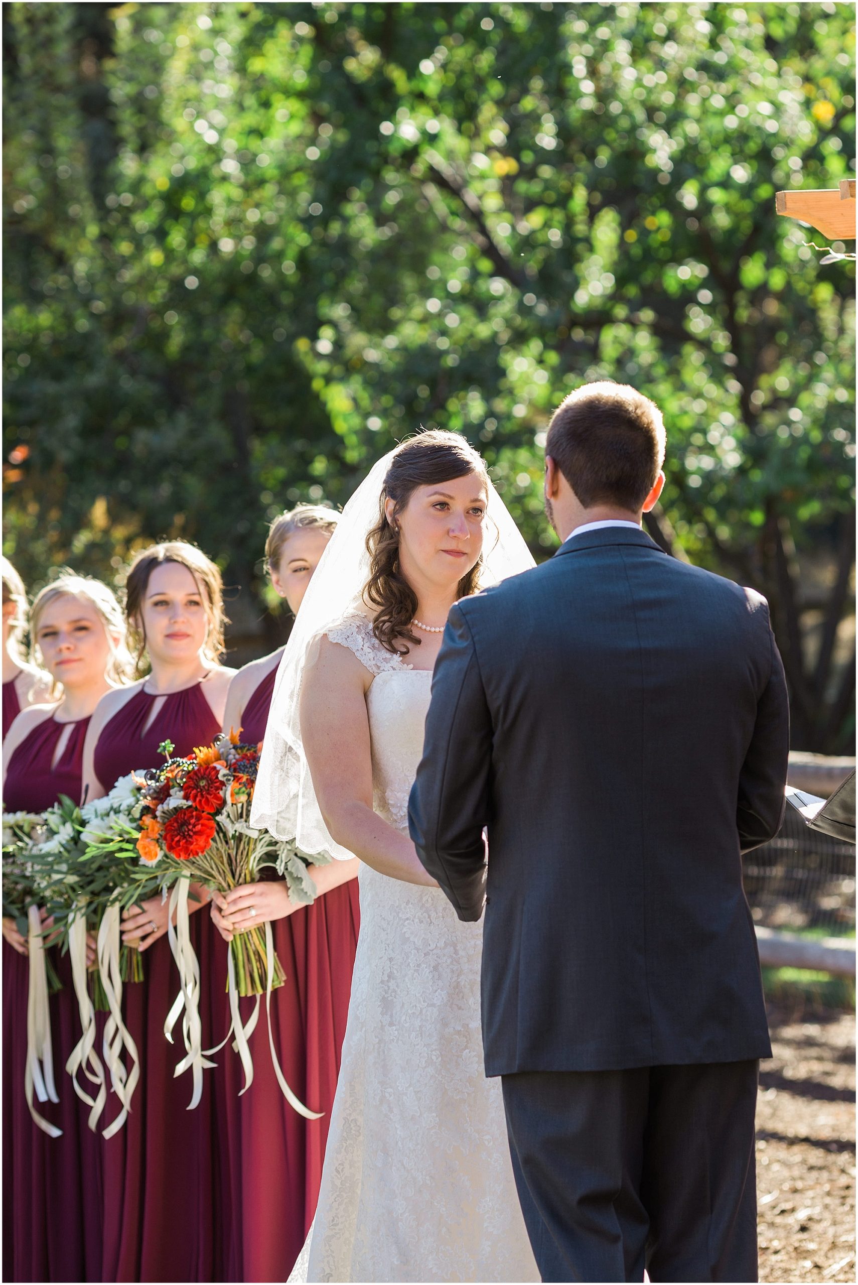 This bride looks longingly into her groom's eyes as she says her wedding vows during their gorgeous fall ceremony at Hollinshead Barn in Bend, OR. | Erica Swantek Photography