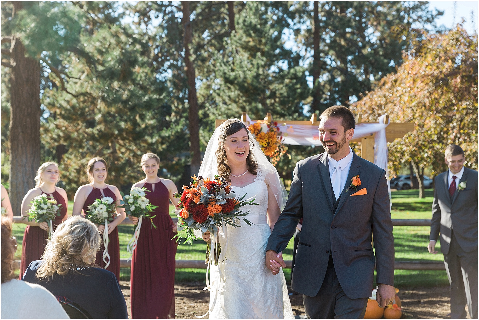 The happy couple is announced husband and wife and cheered on by their family at their Hollinshead Barn fall wedding in Bend, OR. | Erica Swantek Photography