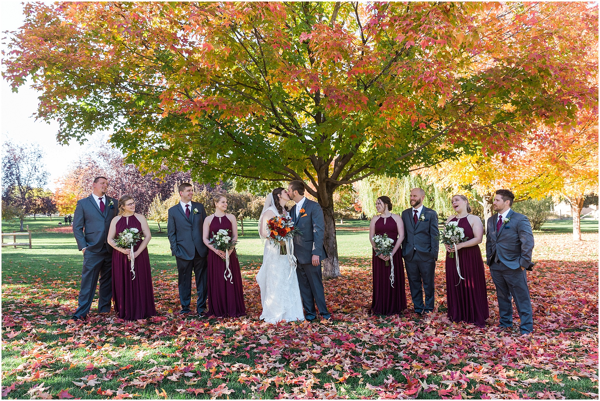 The wedding party poses under the gorgeous maple trees changing color at this Hollinshead Barn fall wedding in Bend, OR. | Erica Swantek Photography
