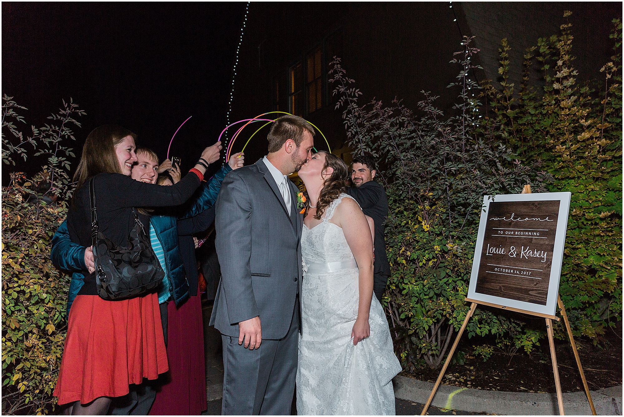 A couple kisses after their glow stick exit from their wedding at Hollinshead Barn in Bend, OR. | Erica Swantek Photography