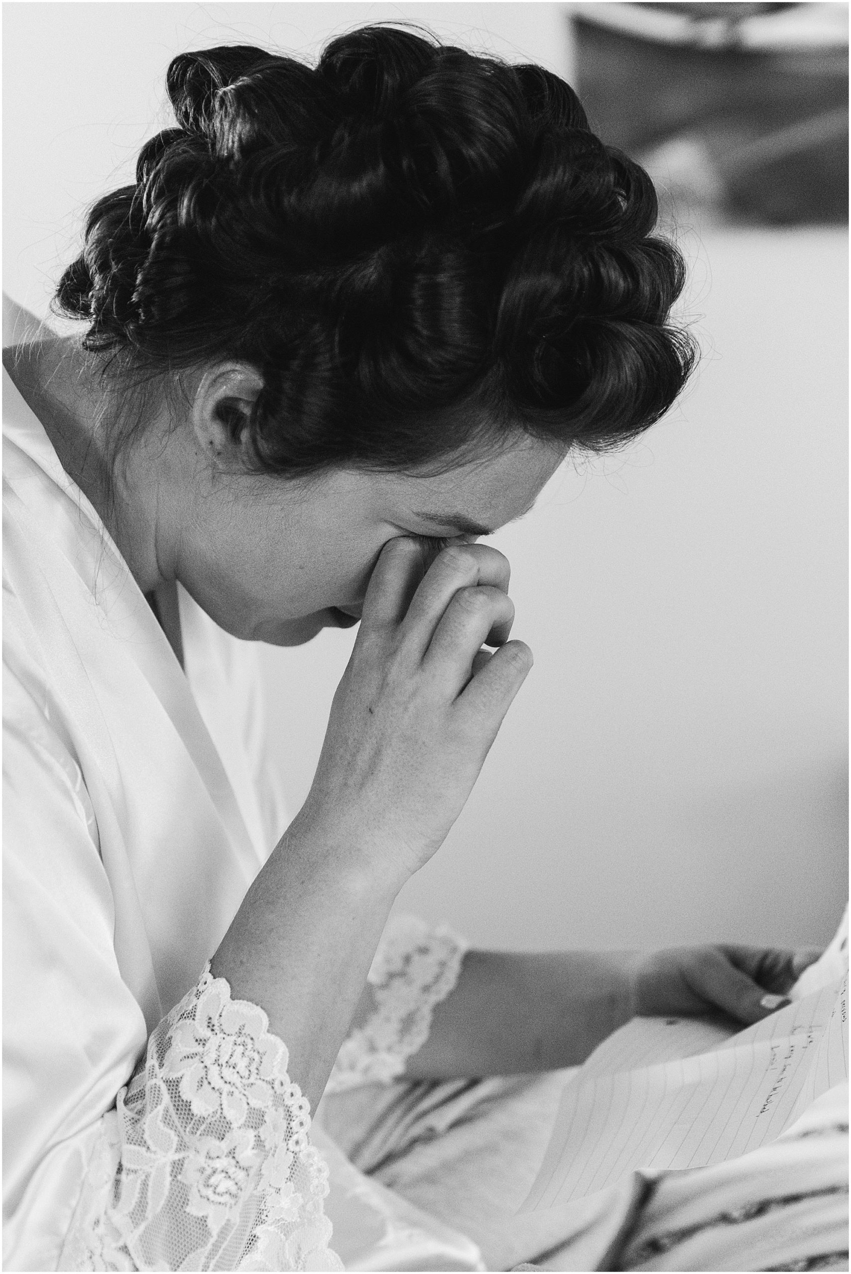 A tearful bride reads a heartfelt love letter from her groom on the morning before her Hollinshead Barn Fall Wedding in Bend, OR. | Erica Swantek Photography