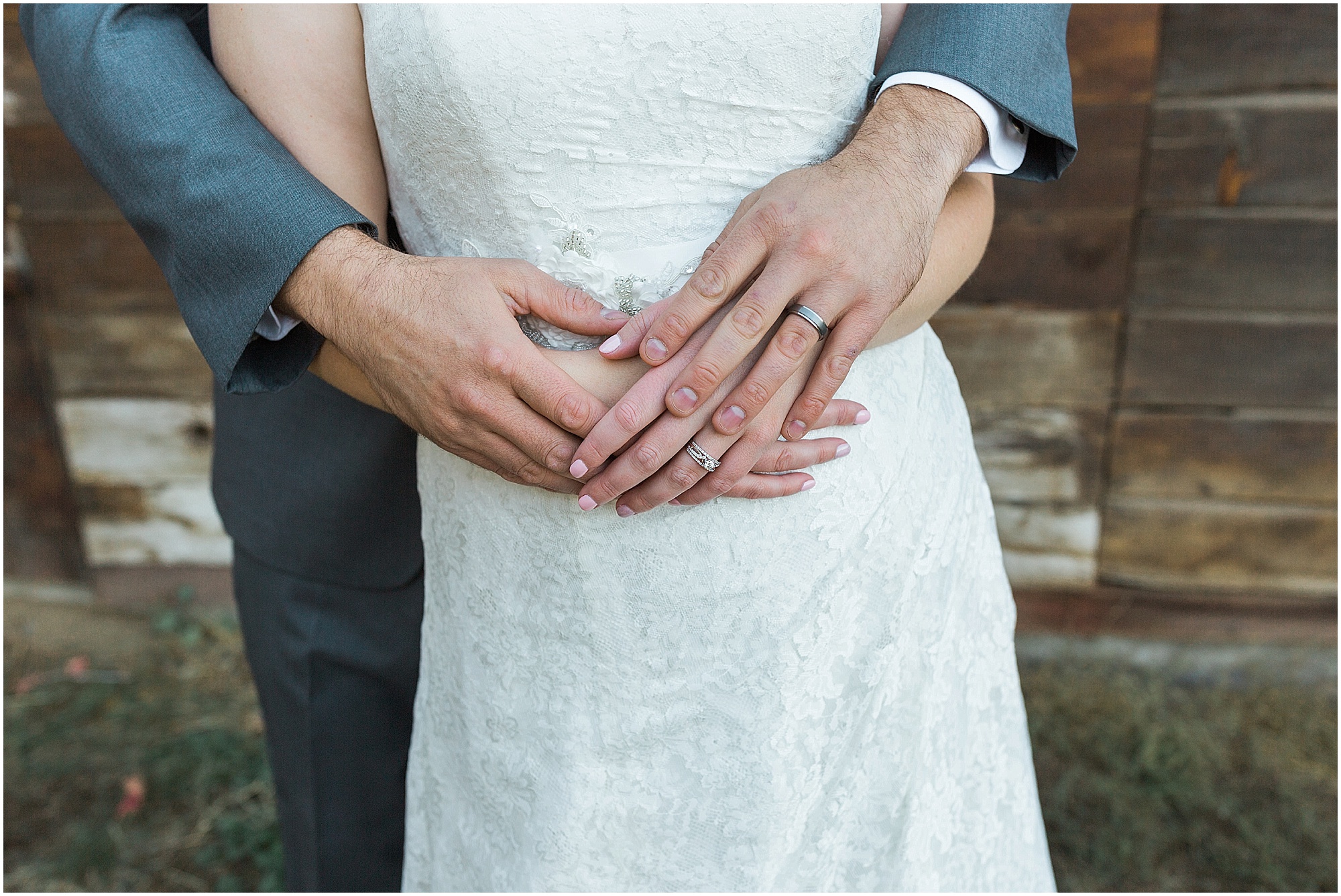 A newly married couple embraces hands at their Hollinshead Barn fall wedding in Bend, OR. | Erica Swantek Photography