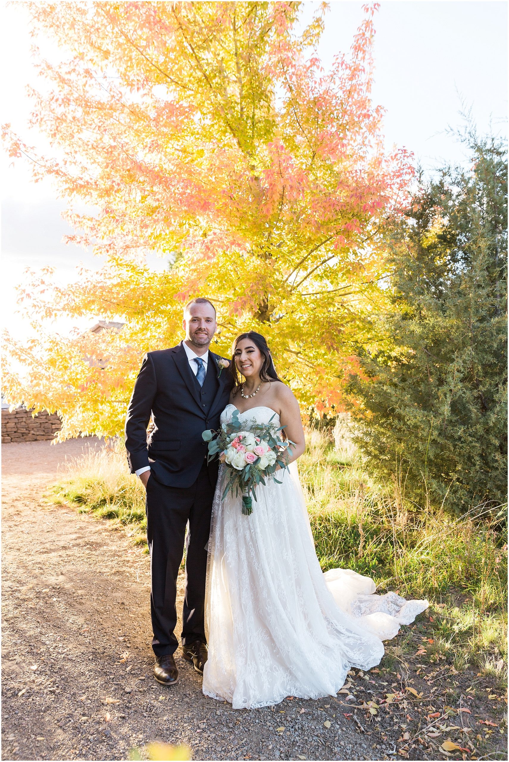 The fall color was just starting to change for at the Tuscan Stables, making for a pretty portrait of the wedding couple at their Ranch at the Canyons fall wedding in Oregon. | Erica Swantek Photography