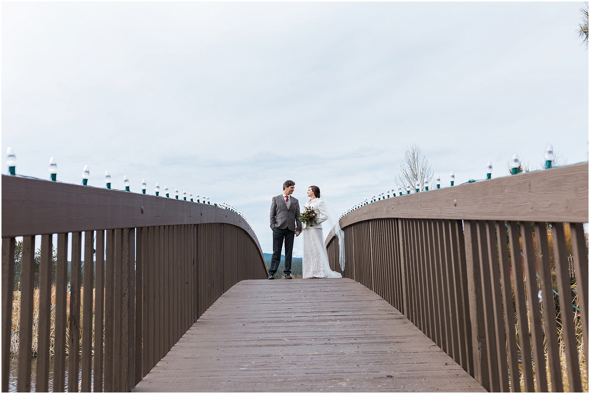 A beautiful bridge over a pond provides an interesting place for a wedding couple's portrait at Sunriver Resort in Oregon. | Erica Swantek Photography