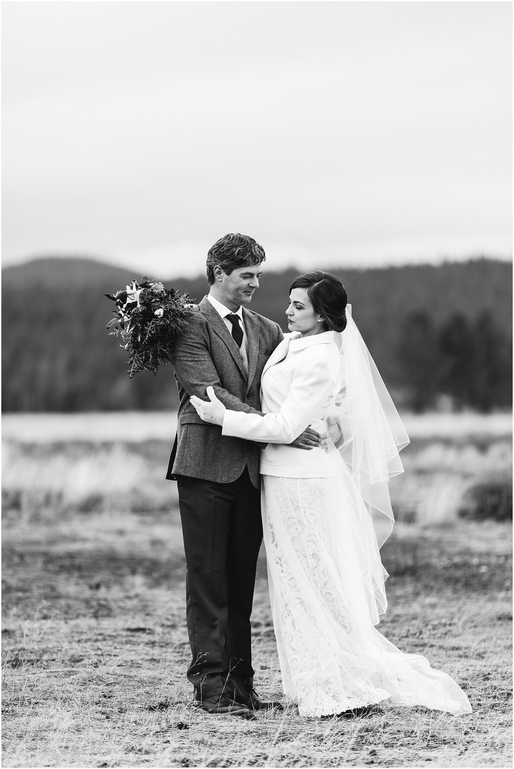 A gorgeous black and white photograph of a couple on their winter wedding day at Sunriver Resort in Oregon. Photographed by Bend Oregon wedding photographer Erica Swantek Photography