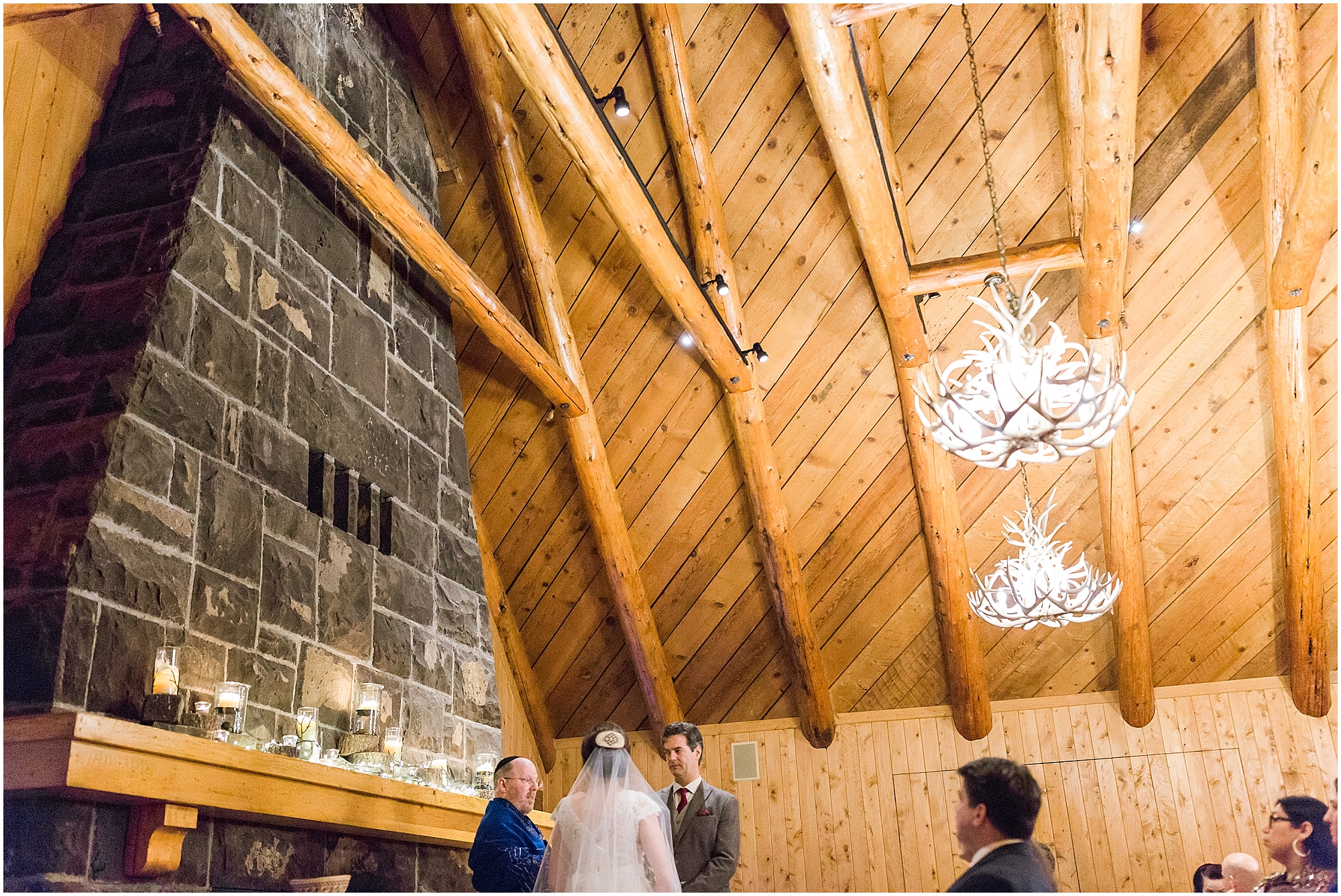 The grand wooden ceiling & stone fireplace at Sunriver Resort provide a warm space for an intimate wedding. | Erica Swantek Photography