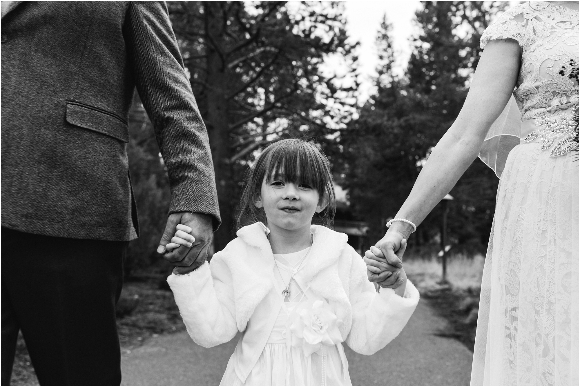 An adorable black and white photo of the bride's daughter at her Sunriver Resort Winter Wedding in Oregon. | Erica Swantek Photography