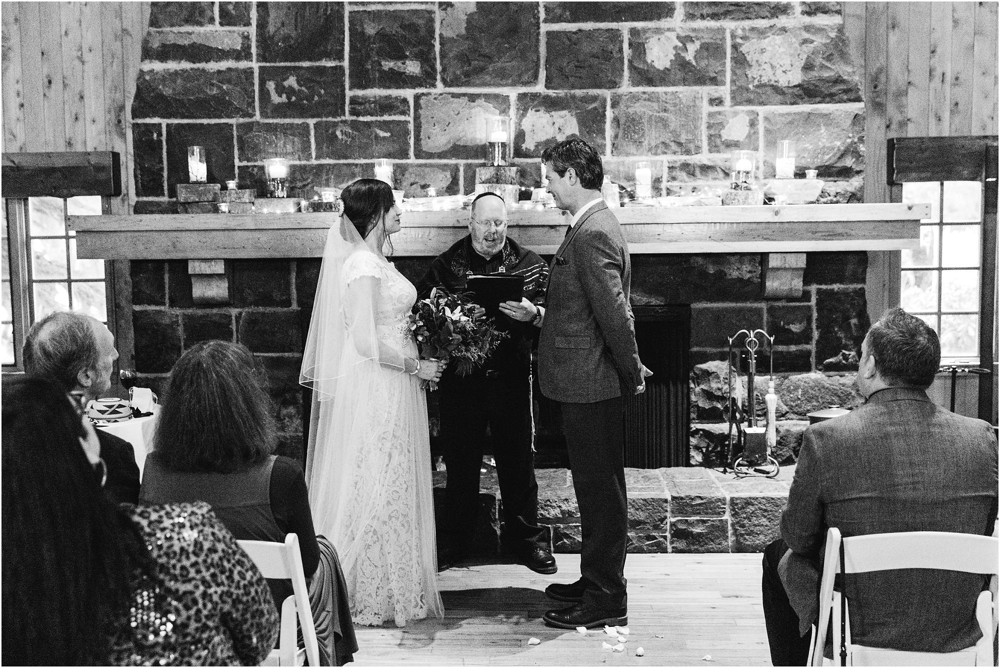 A gorgeous black and white image of an intimate Jewish and Native American wedding ceremony in the Fireside Room of Sunriver Resort in Oregon. | Erica Swantek Photography