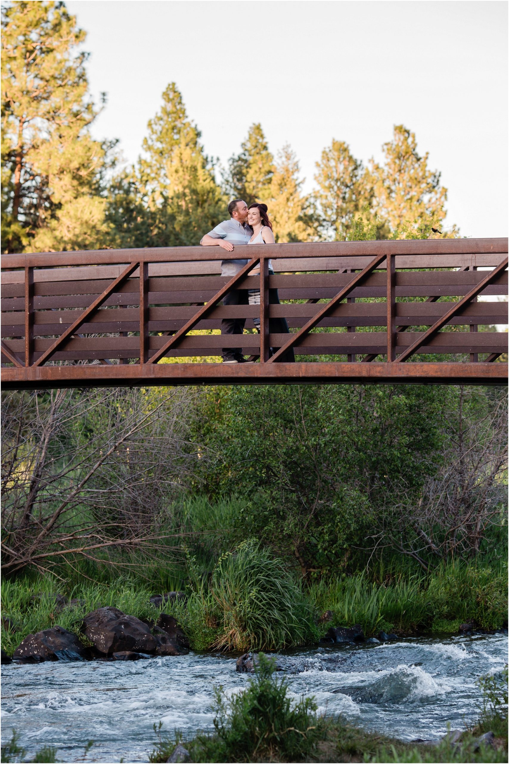 The bridge spanning the Deschutes River at Sawyer Park is a great spot for a couple to have their engagement photos taken in Bend, OR. | Erica Swantek Photography