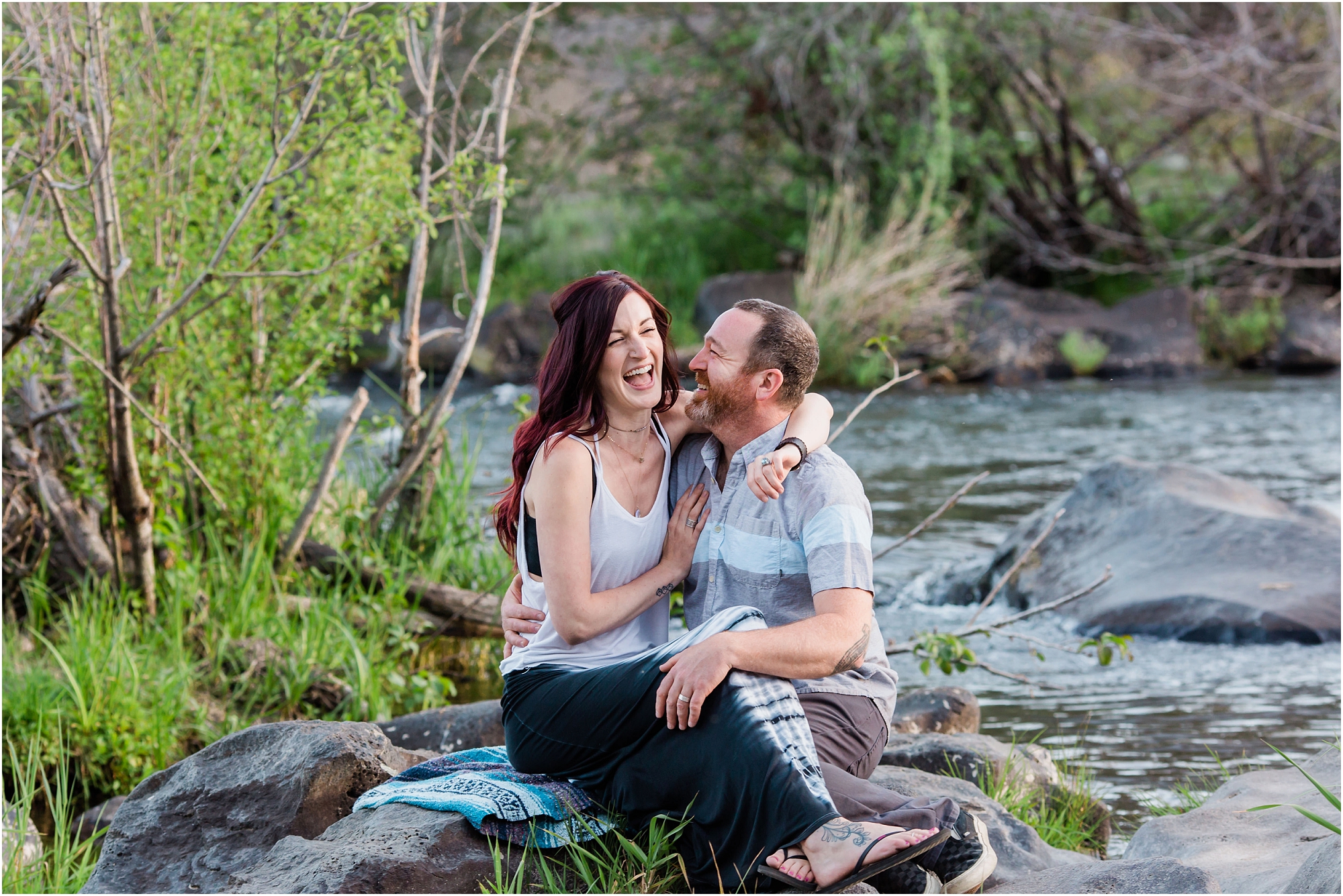 A couple laughs during their sunset engagement session along the river in Bend, OR. | Erica Swantek Photography