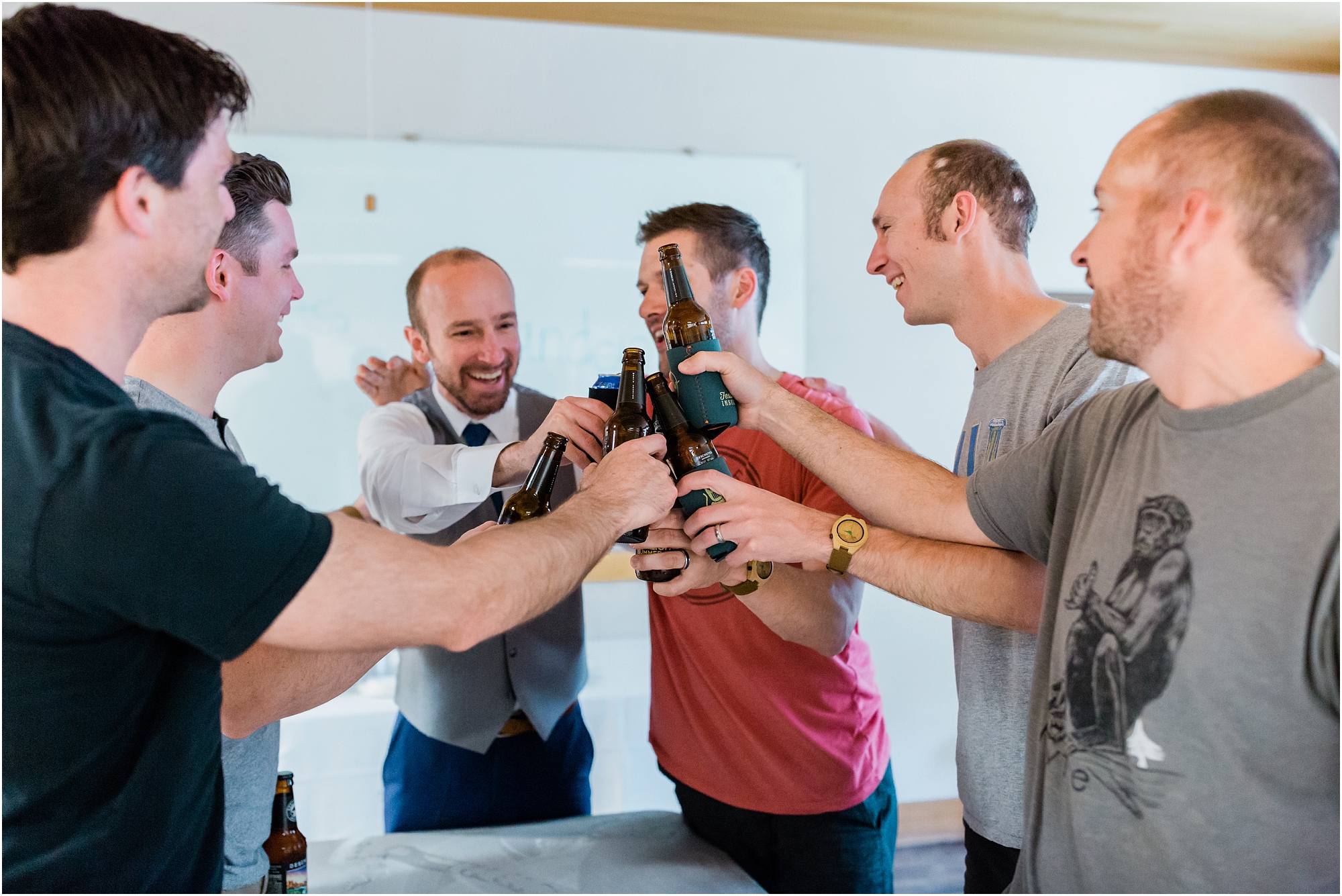 The guy's cheer the groom with a local Oregon craft beer before his wedding at the High Desert Museum in Bend, OR. | Erica Swantek Photography