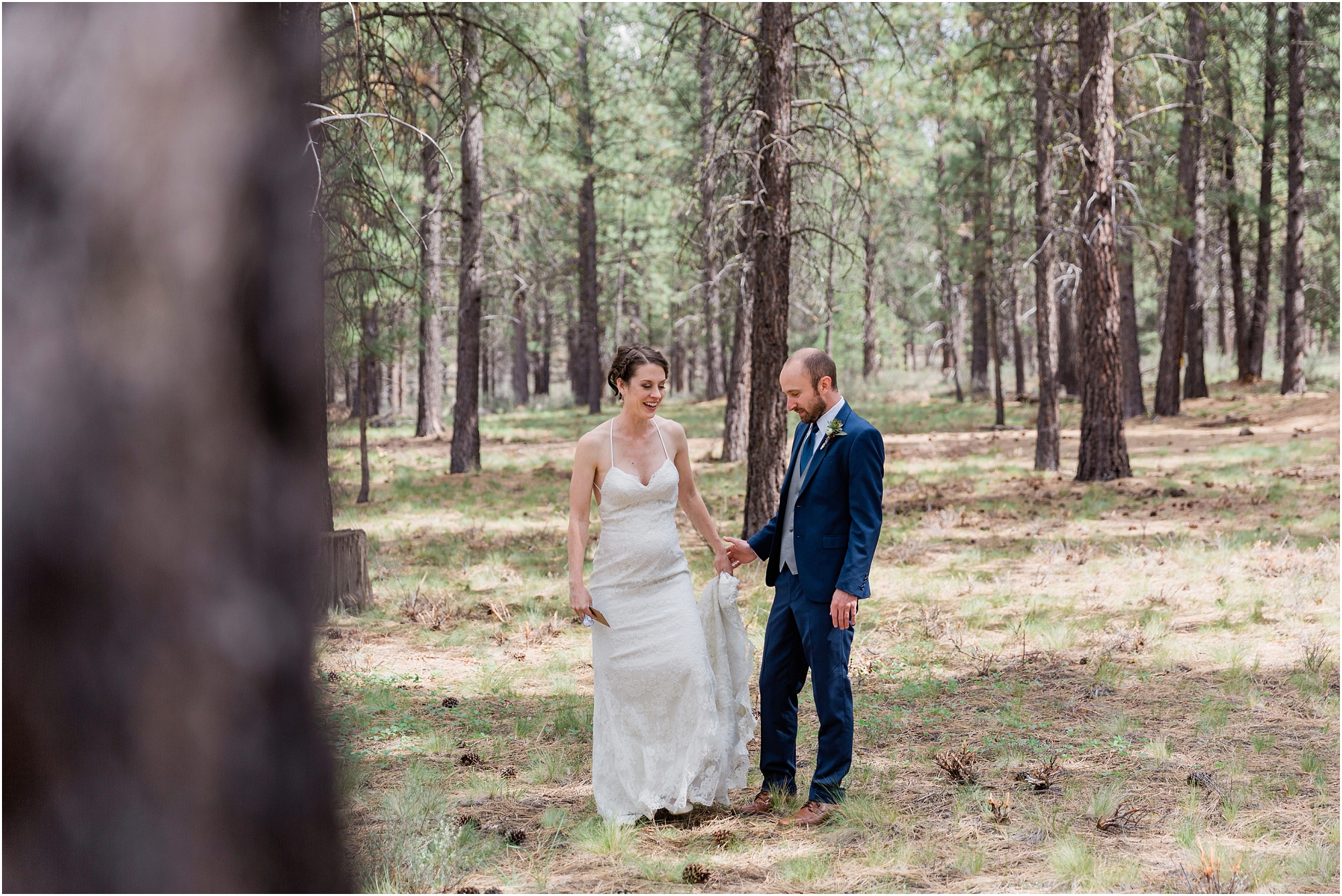 A gorgeous bride wearing BHLDN and a groom in a cobalt blue suit from Men's Warehouse enjoy their first look among the pine trees in Central Oregon. | Erica Swantek Photography