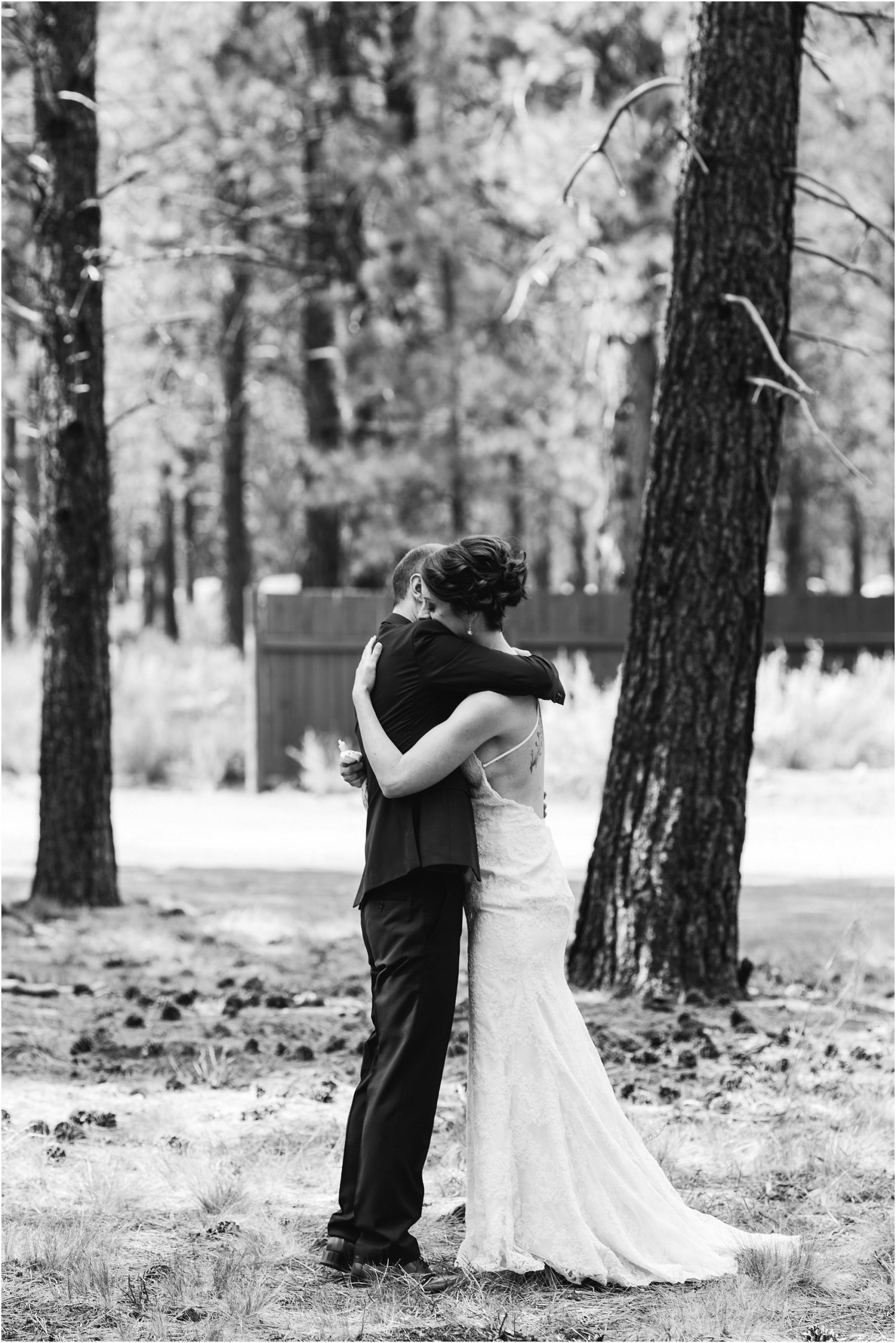 A couple embraces after their first look outside of the High Desert Museum wedding venue in Oregon. | Erica Swantek Photography