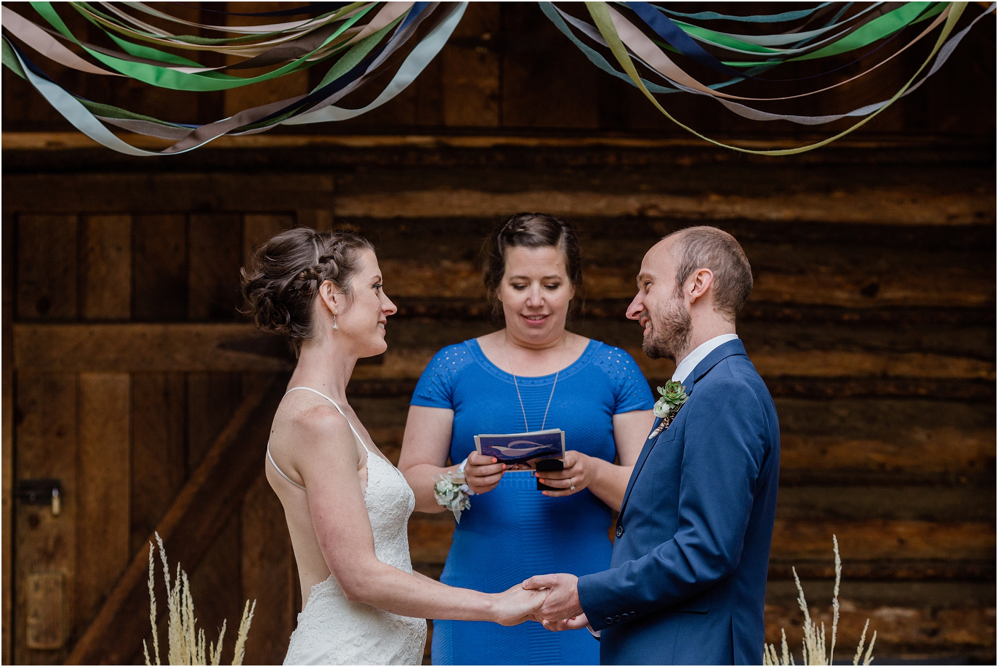 A close up image of the bride and groom as they say their wedding vows on the porch of the rustic cabin at the High Desert Museum in Bend, OR. | Erica Swantek Photography