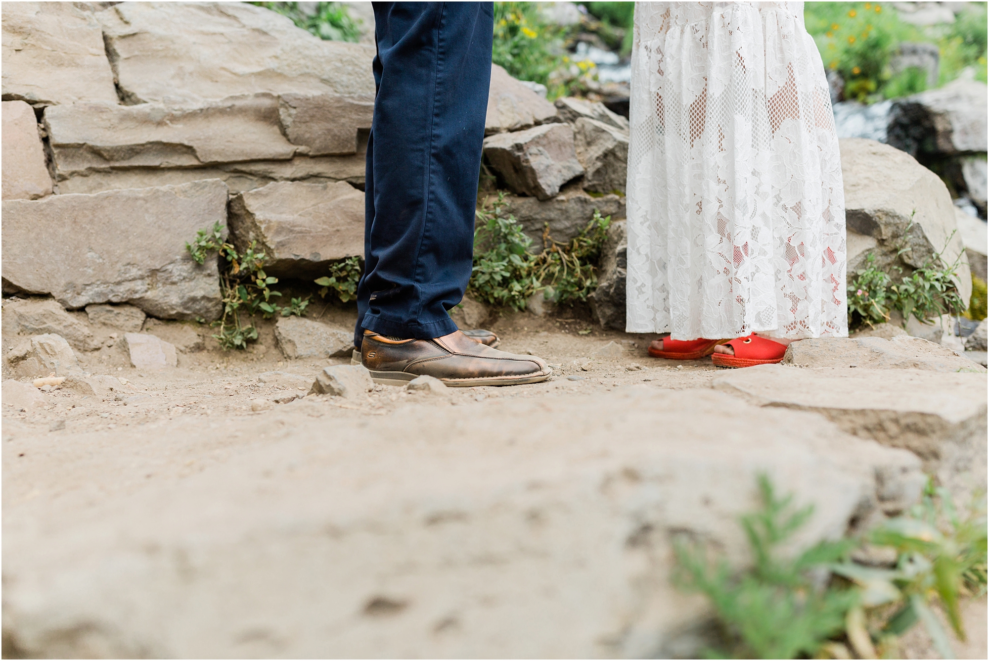 A detail photo of the bride's red rainbow wedge shoes and the groom's leather shoes during their intimate wedding ceremony in Crater Lake National Park. | Erica Swantek Photography