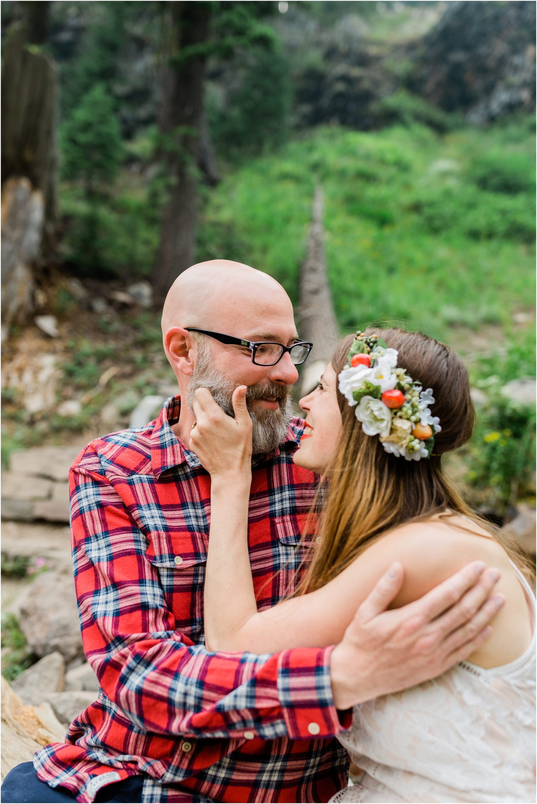 The bride looks adoringly into her husband's eye's as she grabs his beard after they said their wedding vows at Crater Lake in Oregon. | Erica Swantek Photography