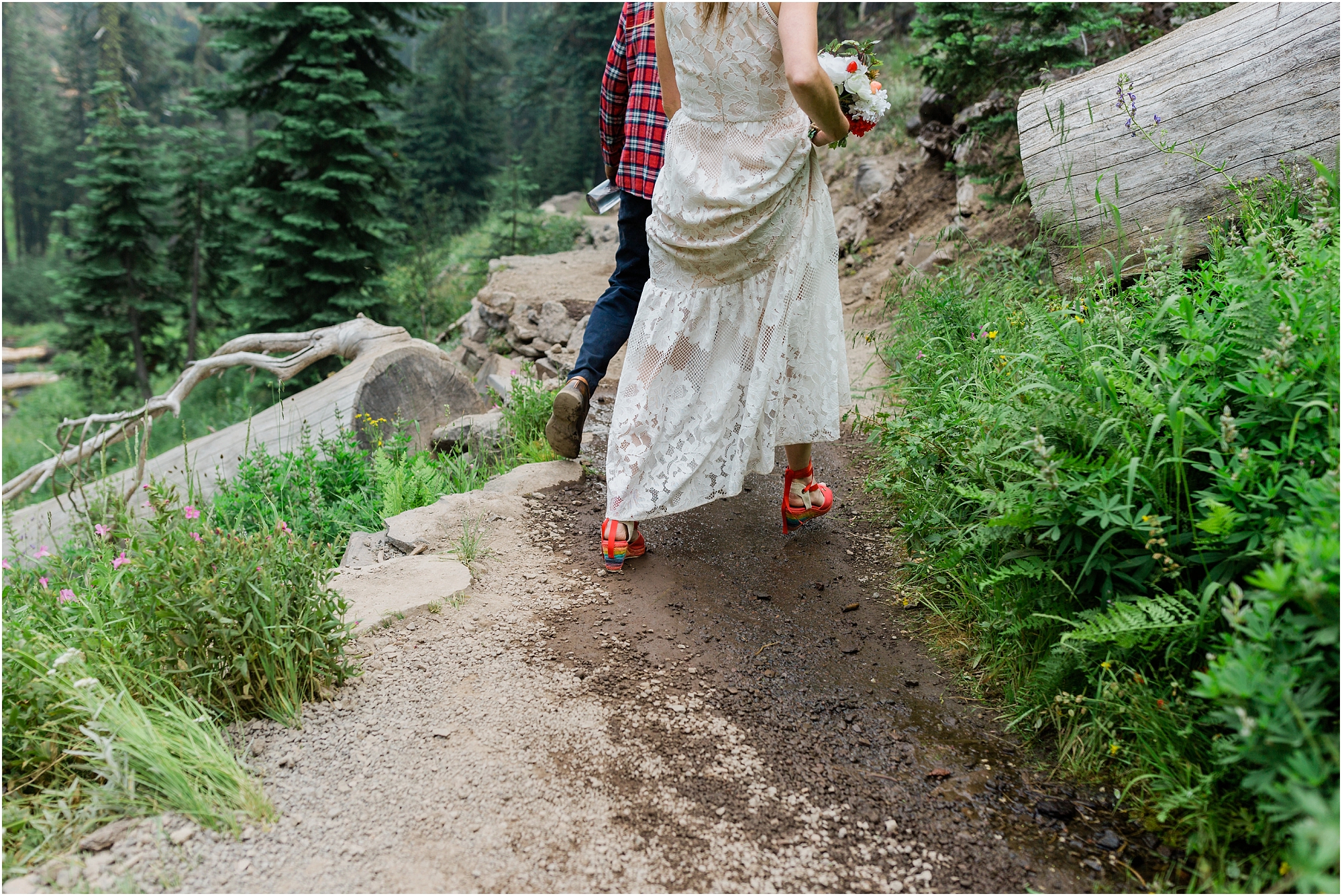 A couple that isn't afraid to get a little dirty as they hike back down the trail after they eloped in Crater Lake. | Erica Swantek Photography