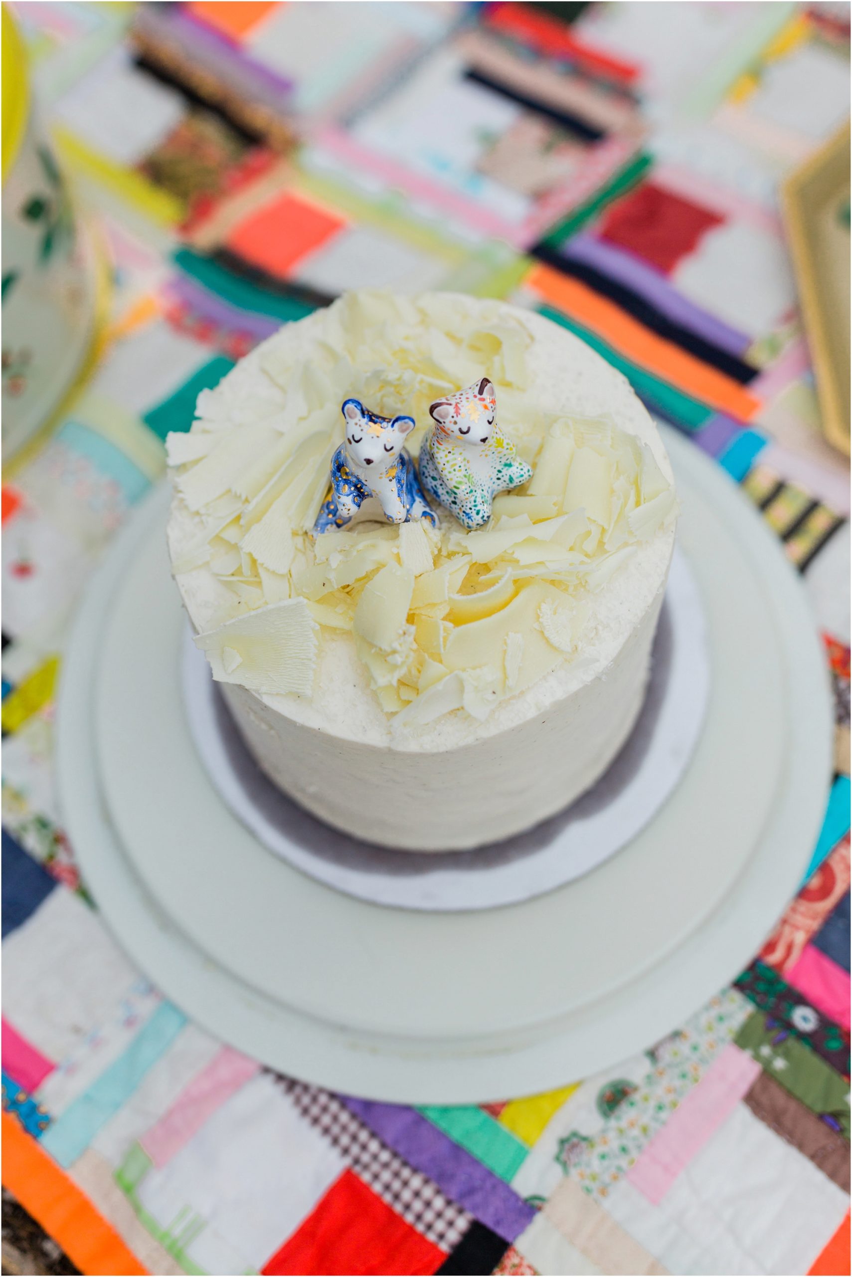 A delicious foxtail bakeshop cake with adorable hand painted figure toppers in all colors of the rainbow for an Oregon elopement at Crater Lake National Park. | Erica Swantek Photography