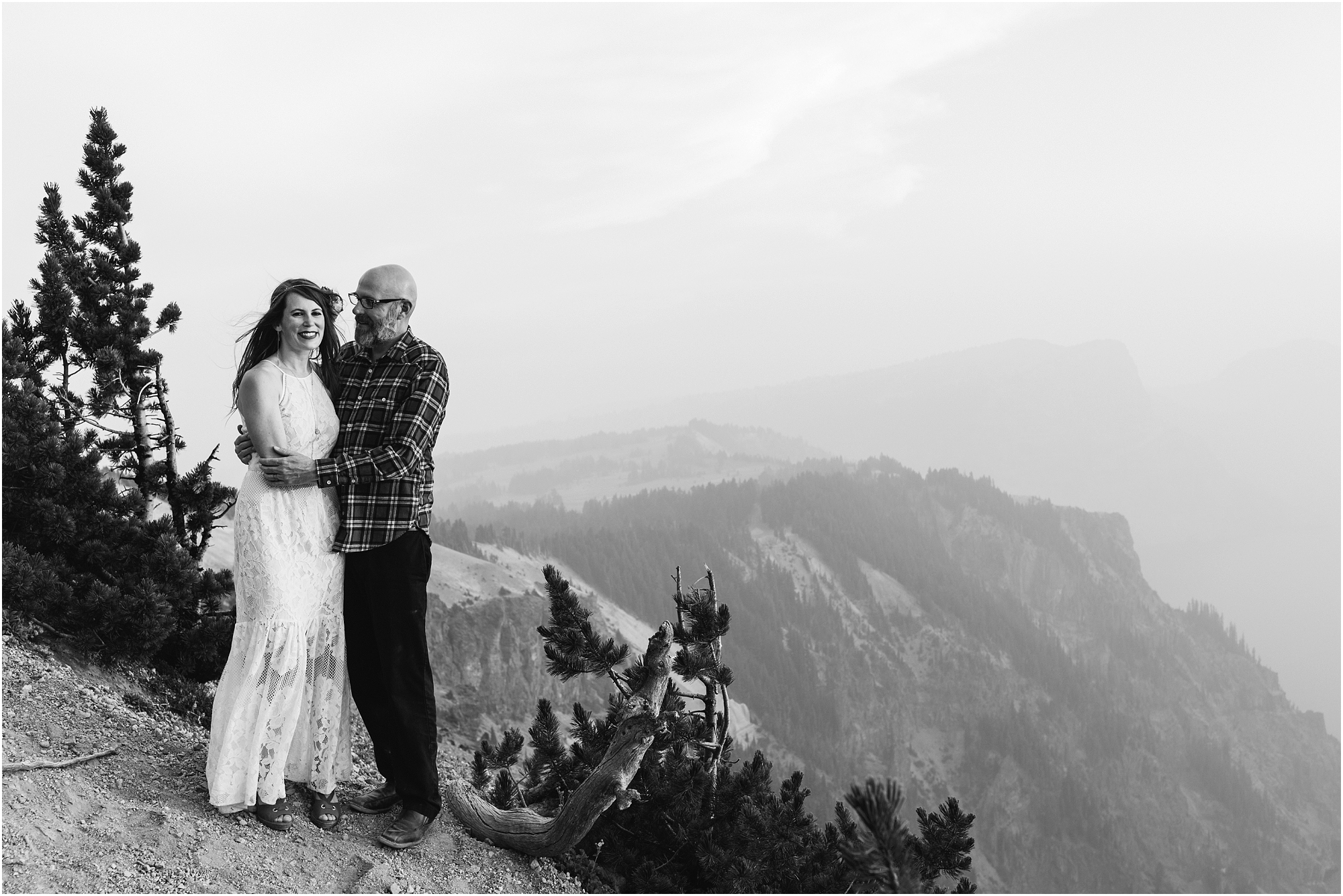 A moody black and white photograph of a wedding couple posing at Cloud Cap Overlook in Crater Lake National Park in Oregon. | Erica Swantek Photography