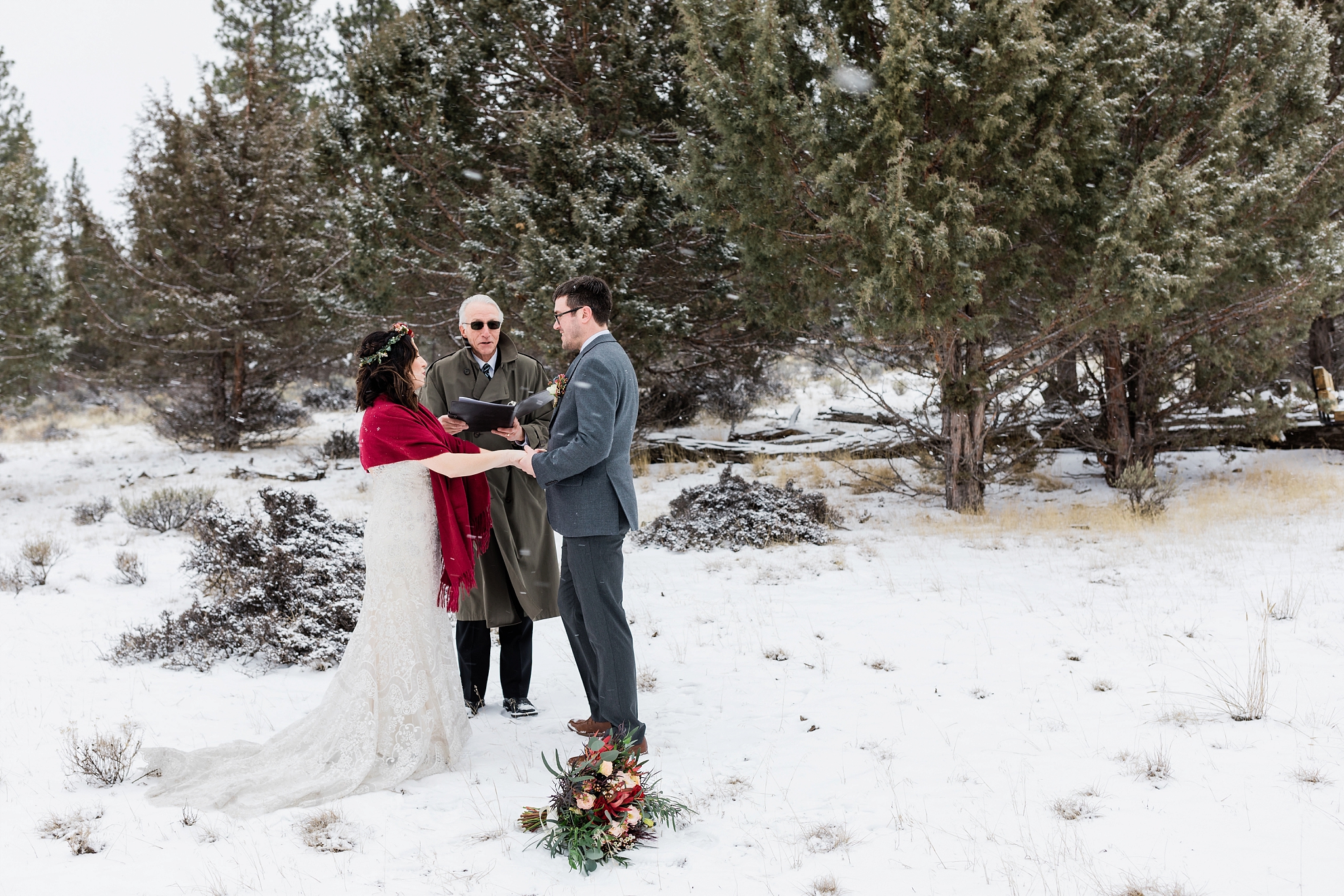 A winter elopement near Sisters, Oregon with the bride wearing a gorgeous red shawl. | Erica Swantek Photography
