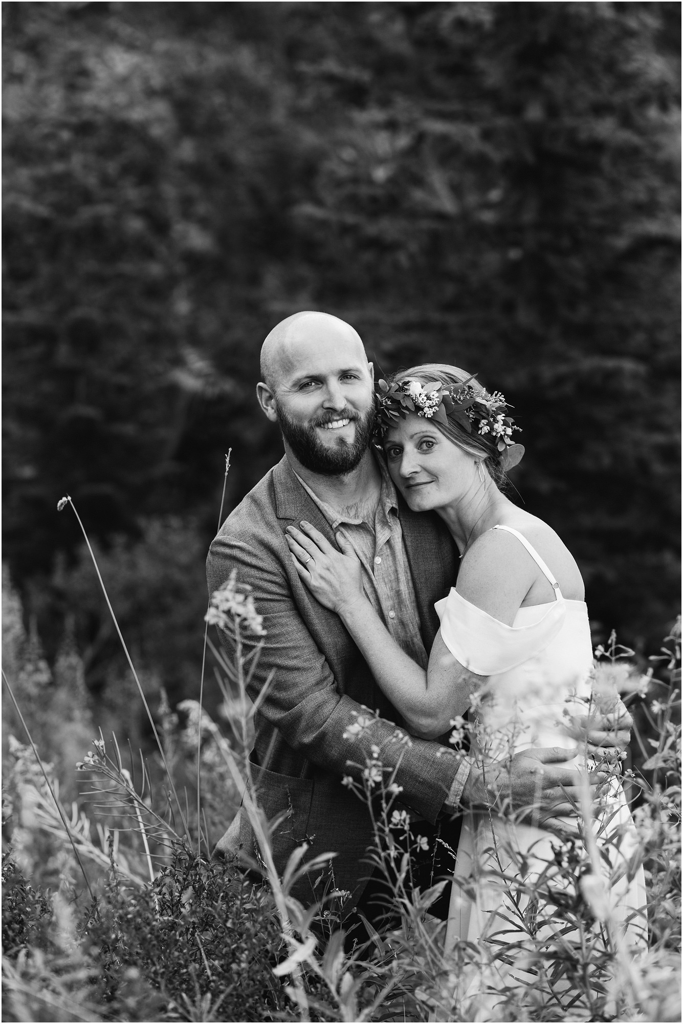 A gorgeous black and white photograph of a newly married couple as they adventure around for photos at their Tumalo Falls elopement in Bend, OR. | Erica Swantek Photography