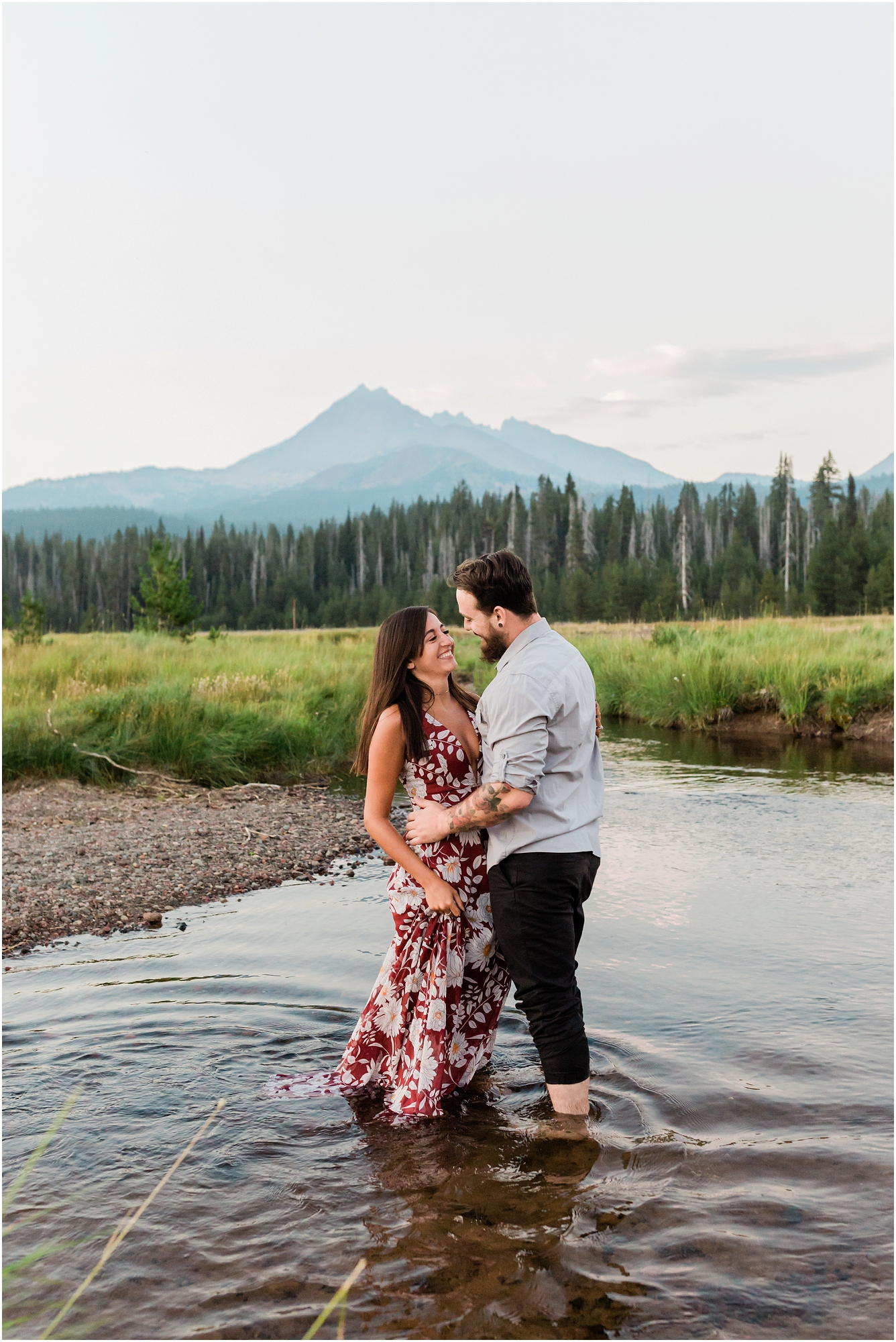 A couple stands in a mountain stream during their Sparks Lake Oregon engagement session near Bend. | Erica Swantek Photography