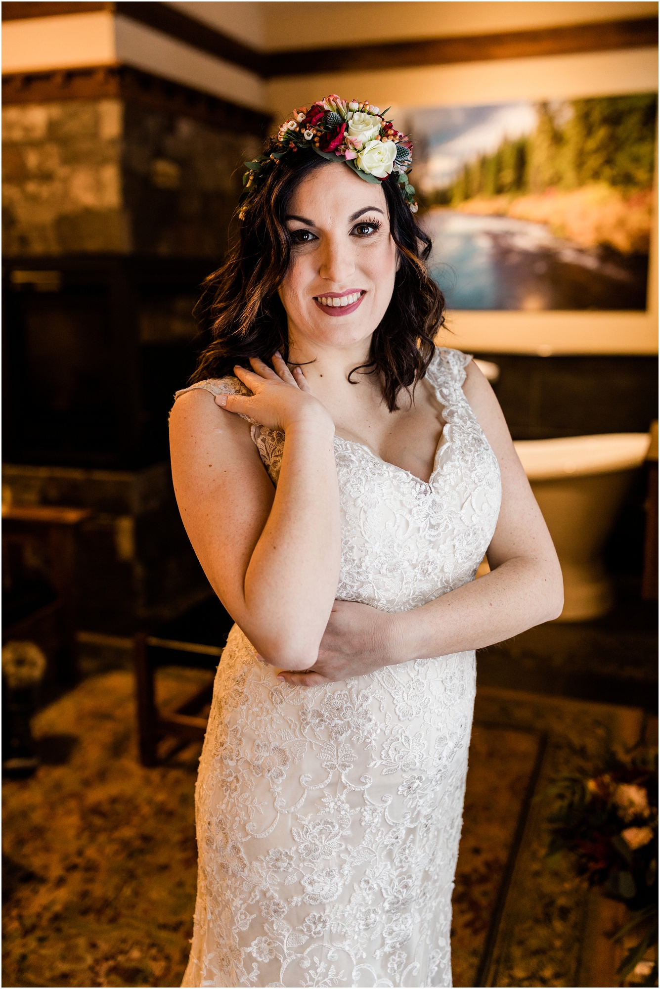 A gorgeous bride with a floral crown poses with her hand resting on her shoulder as she gets ready to see her groom for the first look outside her cabin door at Five Pine Lodge for her Central Oregon winter elopement. | Erica Swantek Photography