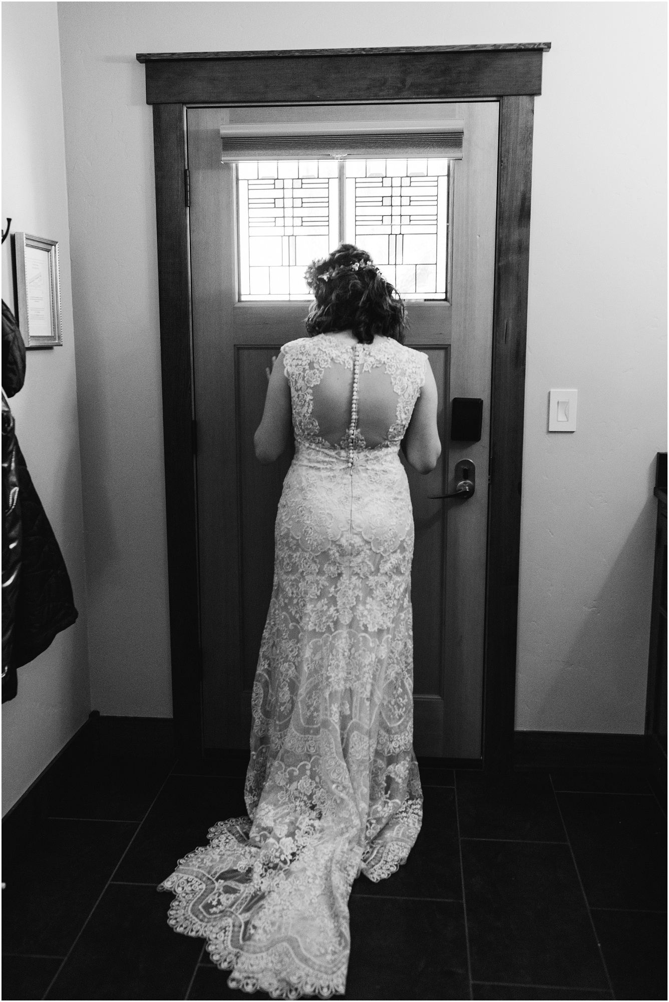 A bride waits at the front door for her first look before her Central Oregon winter elopement at Five Pine Lodge in Sisters. | Erica Swantek Photography