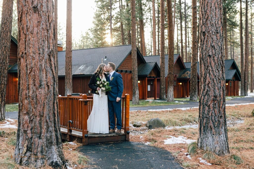 bride and groom kissing during their fivepine lodge wedding day