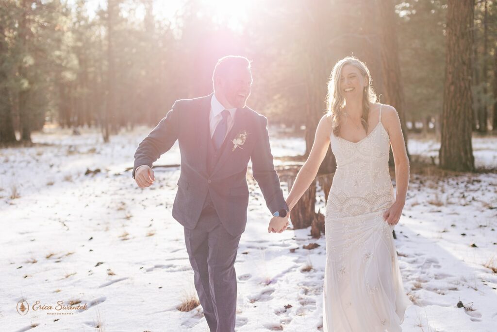 bride and groom walking hand in hand during their fivepine lodge wedding day