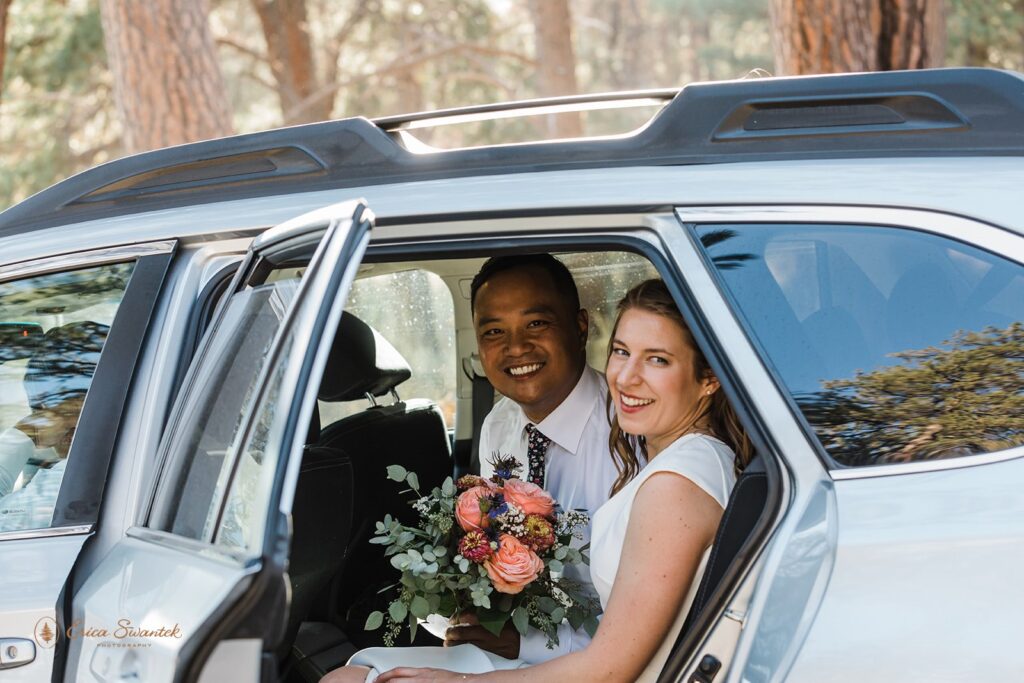 a smiley elopement couple sitting the car on the way to their bend oregon elopement