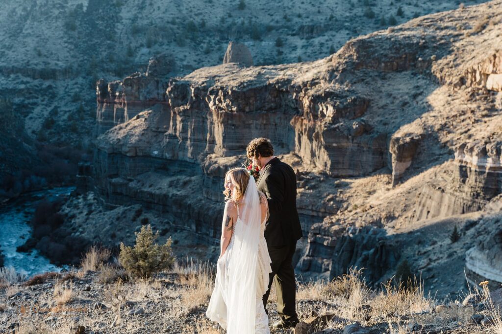 bride and groom walking hand in hand during their elopement at oregon high desert