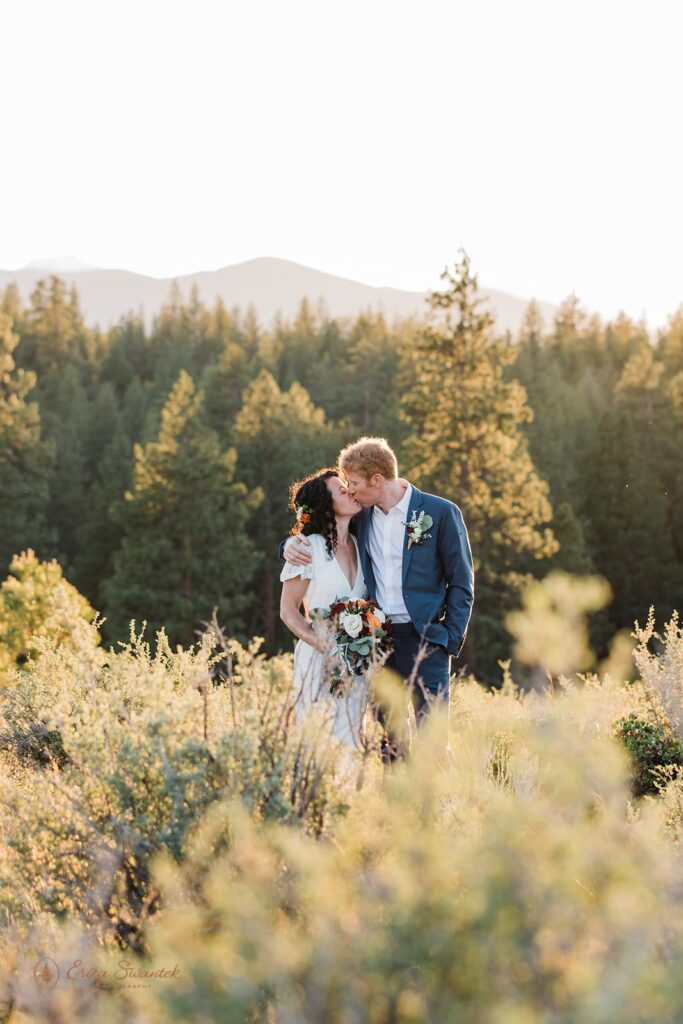 bride and groom in a lush sunlit field during their bend oregon elopement day