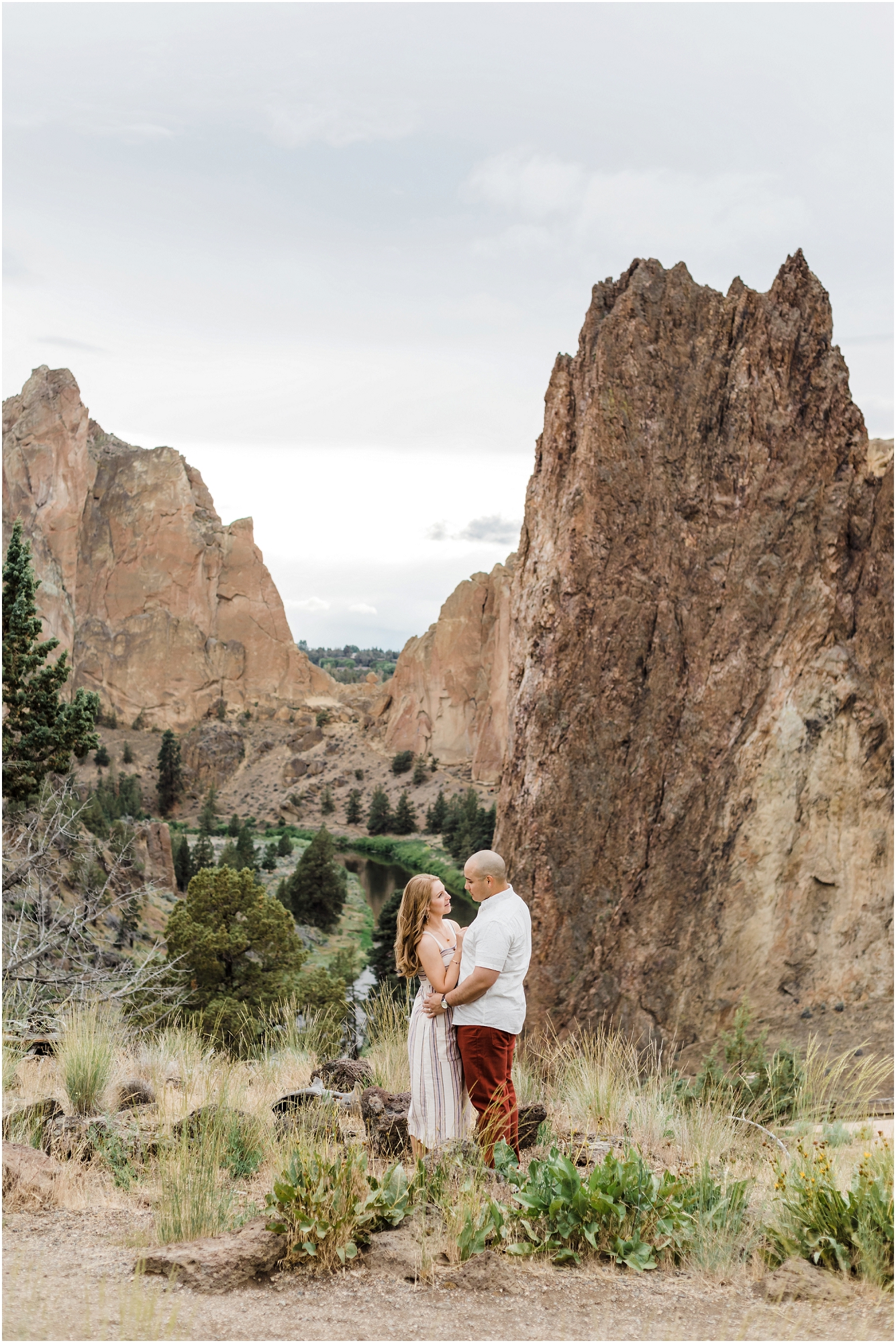 A couple stands in Oregon's iconic Smith Rock State Park for their wedding anniversary photo session with Oregon elopement photographer Erica Swantek Photography. 