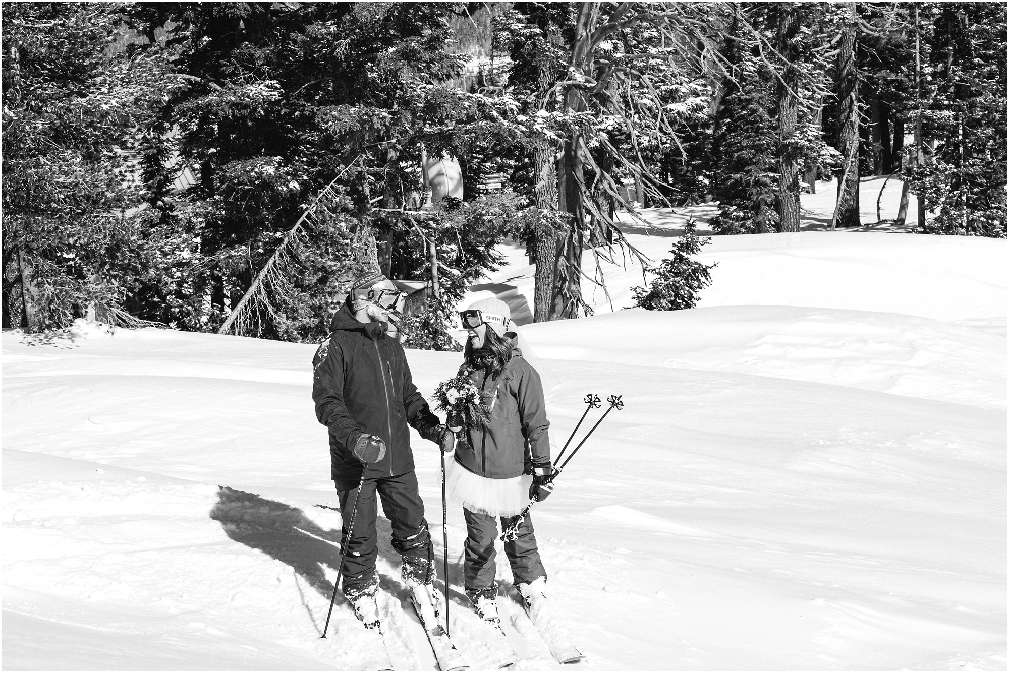 A black and white image of a bride and groom in their ski clothes after saying their vows at Mt Bachelor in Oregon. | Erica Swantek Photography