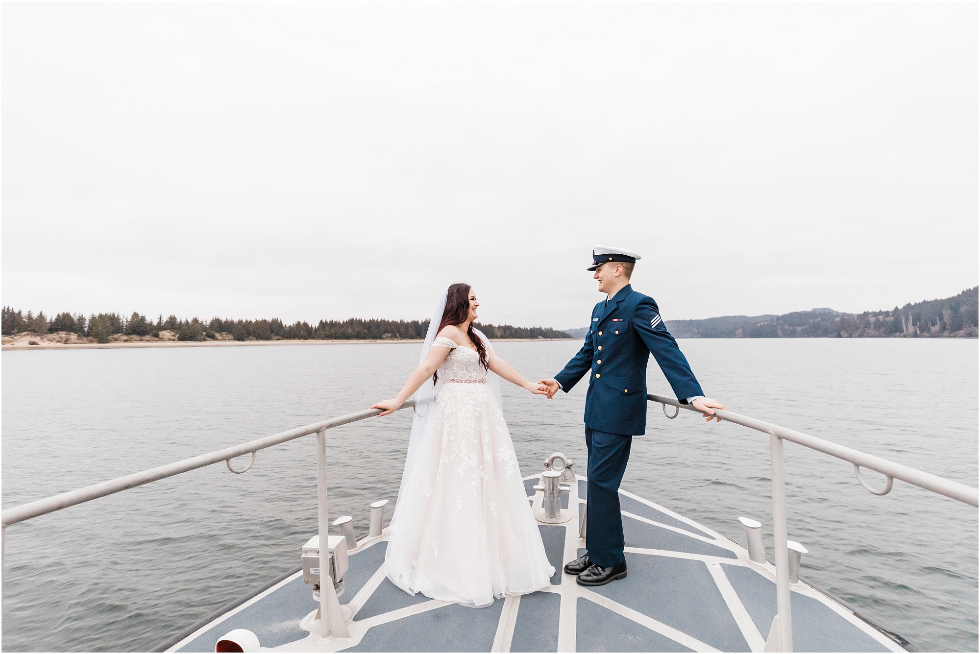 An Oregon Coast Guard elopement, officiated on the deck of the ship in Winchester Bay, Oregon with a groom wearing his navy Coast Guard uniform and a bride wearing a blush pink gown and white veil. | Erica Swantek Photography